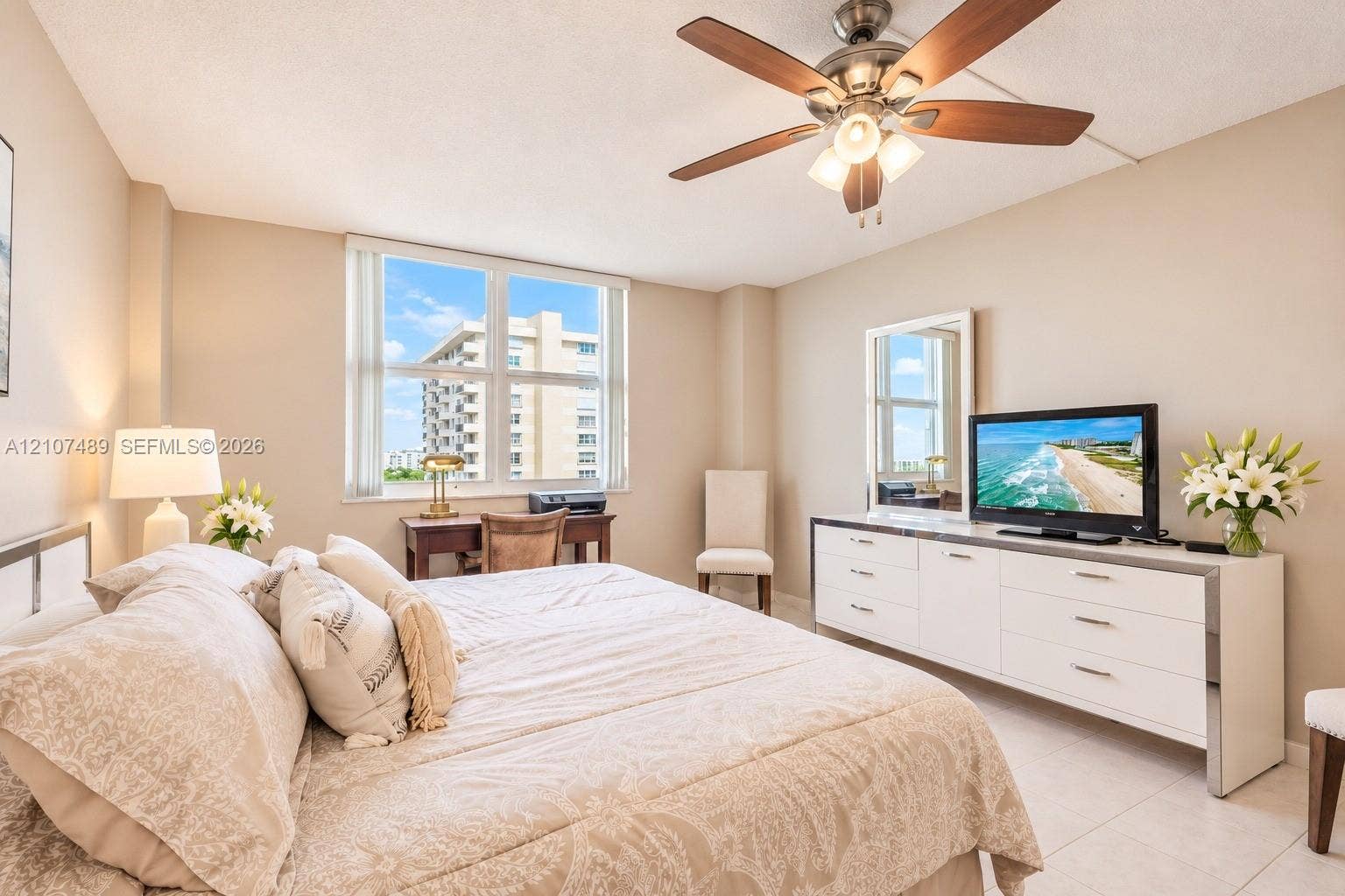 2000 S Ocean Boulevard, #9N, Lauderdale-By-The-Sea, Lauderdale By The Sea, FL 33062 Neutral-toned room featuring large windows, light-colored tile flooring, and a ceiling-mounted fan with integrated lighting
