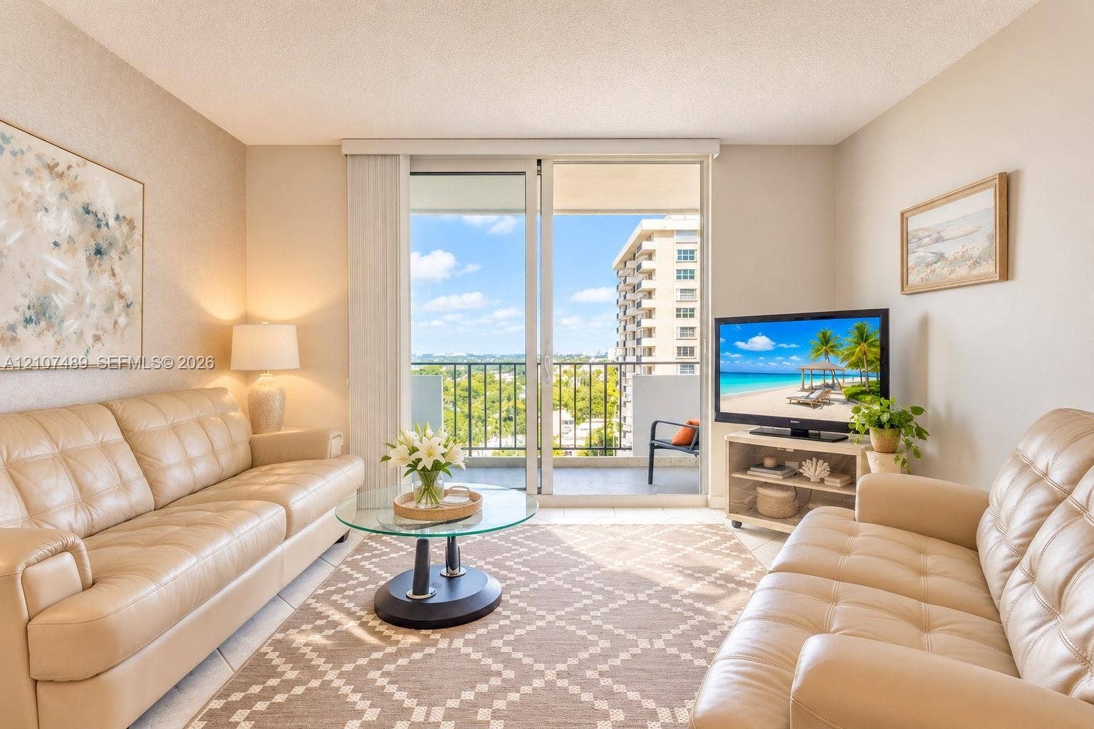 2000 S Ocean Boulevard, #9N, Lauderdale-By-The-Sea, Lauderdale By The Sea, FL 33062 Living area featuring sliding glass doors leading to a private balcony with metal railings and neutral tile flooring