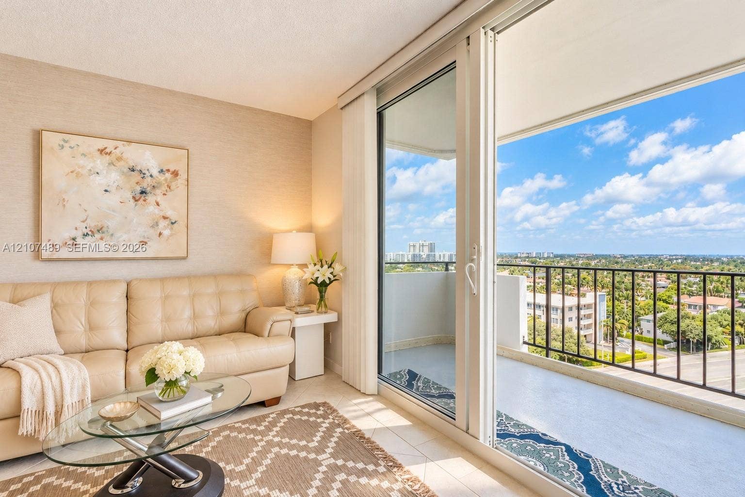 2000 S Ocean Boulevard, #9N, Lauderdale-By-The-Sea, Lauderdale By The Sea, FL 33062 Floor-to-ceiling sliding glass doors opening to a private balcony with metal railing, neutral textured wall covering, and light-toned tile flooring