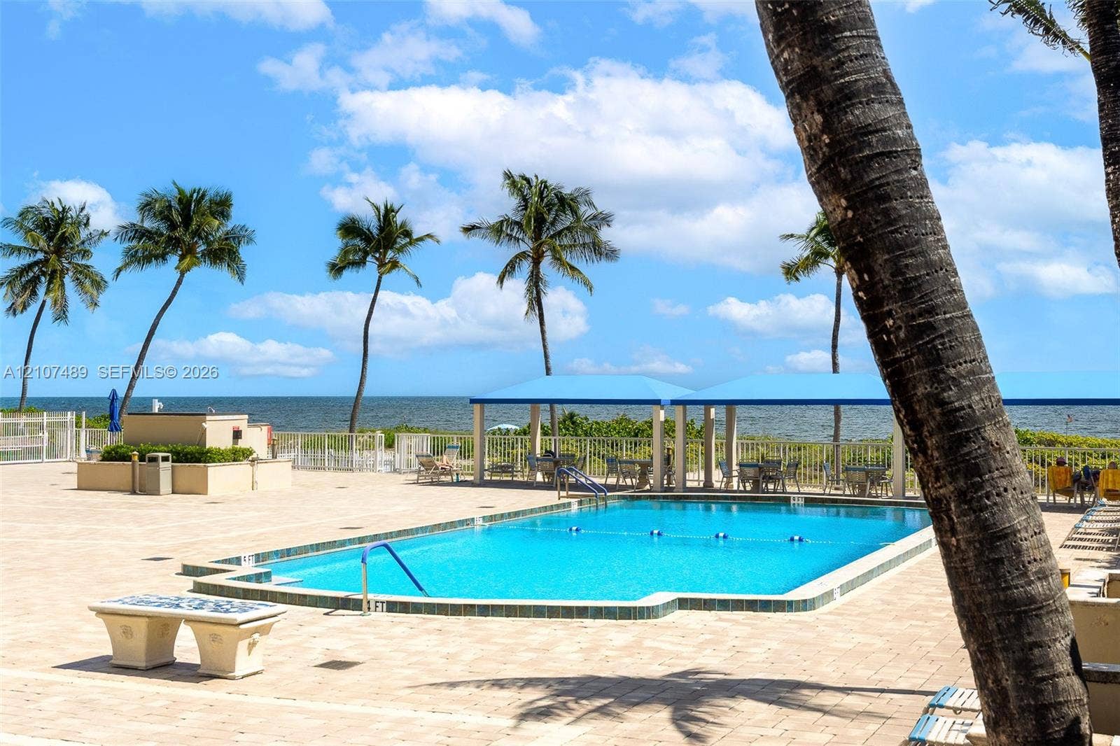2000 S Ocean Boulevard, #9N, Lauderdale-By-The-Sea, Lauderdale By The Sea, FL 33062 Outdoor swimming pool featuring stone tile decking, a covered pavilion, built-in masonry benches, and water frontage