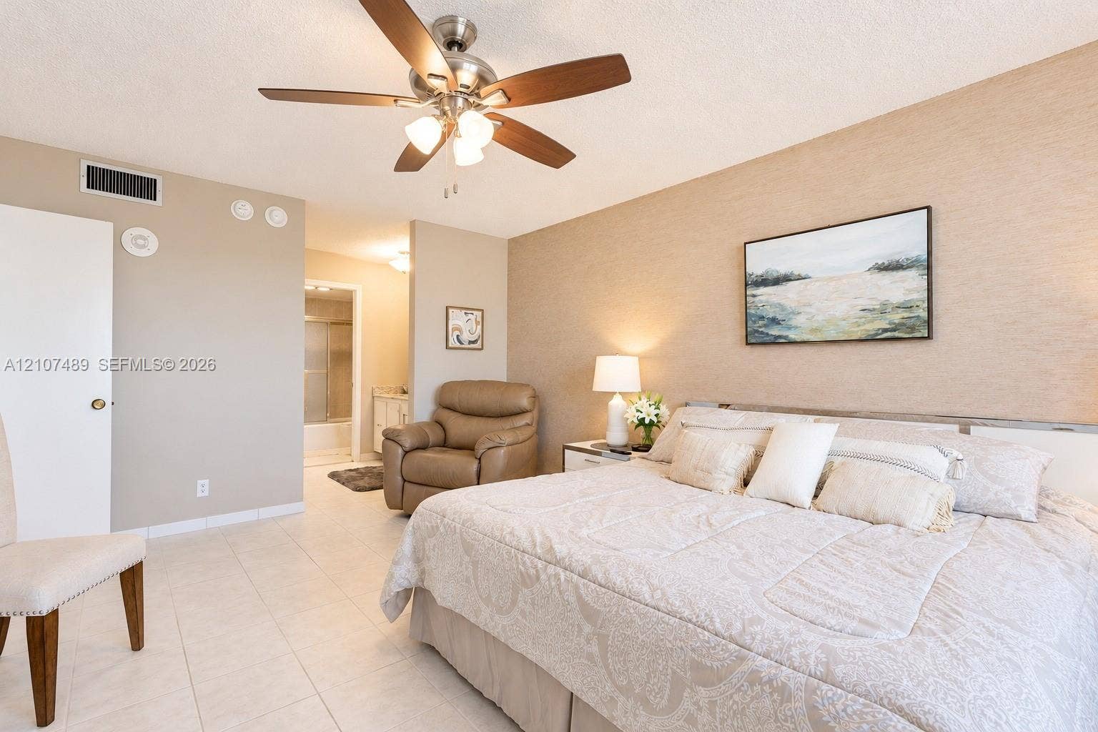 2000 S Ocean Boulevard, #9N, Lauderdale-By-The-Sea, Lauderdale By The Sea, FL 33062 Spacious room featuring neutral tile flooring, a brushed-nickel ceiling fan with integrated lighting, and textured wall finish