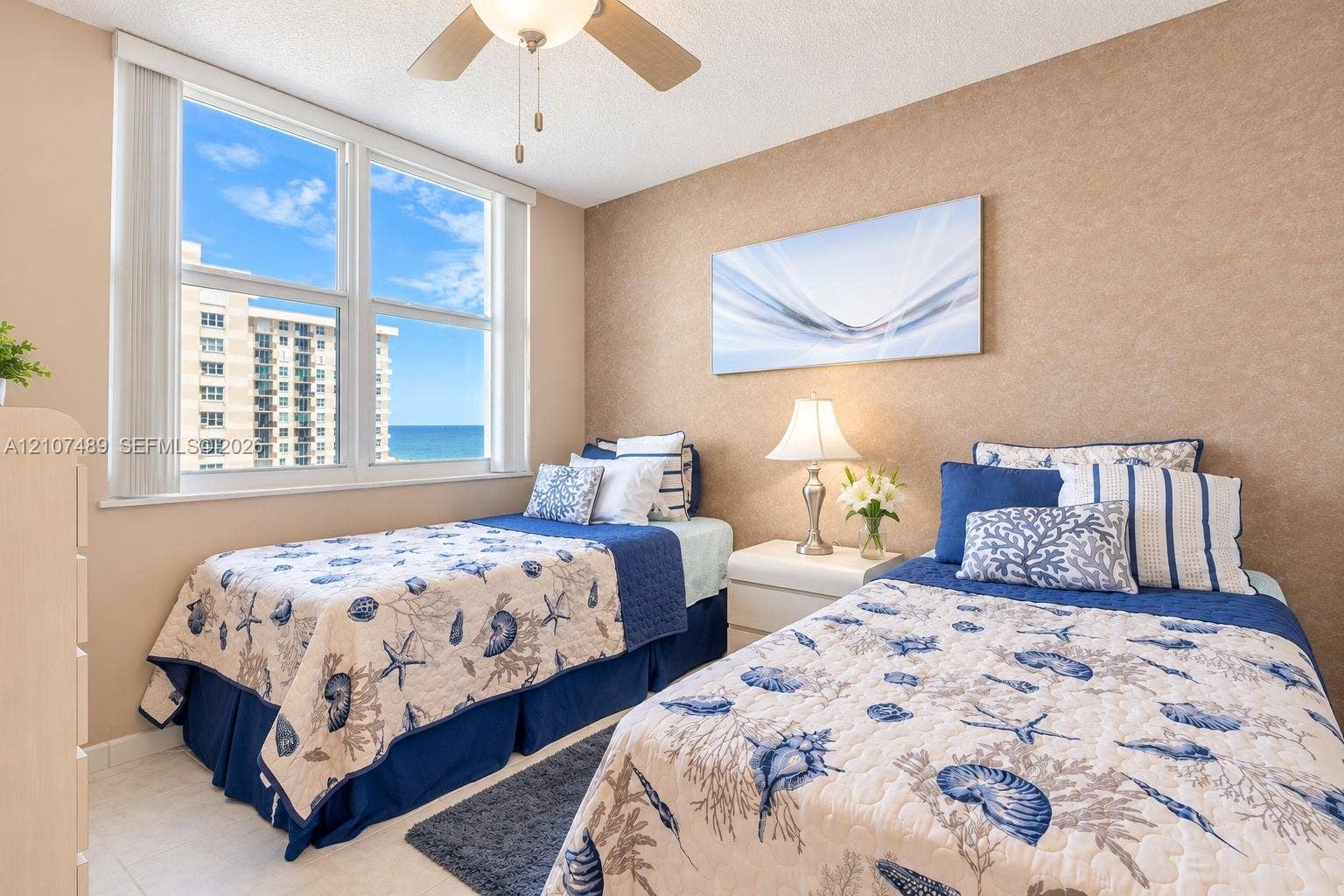 2000 S Ocean Boulevard, #9N, Lauderdale-By-The-Sea, Lauderdale By The Sea, FL 33062 Large windows featuring natural light, neutral textured wall finish, and ceiling-mounted fan with light fixture