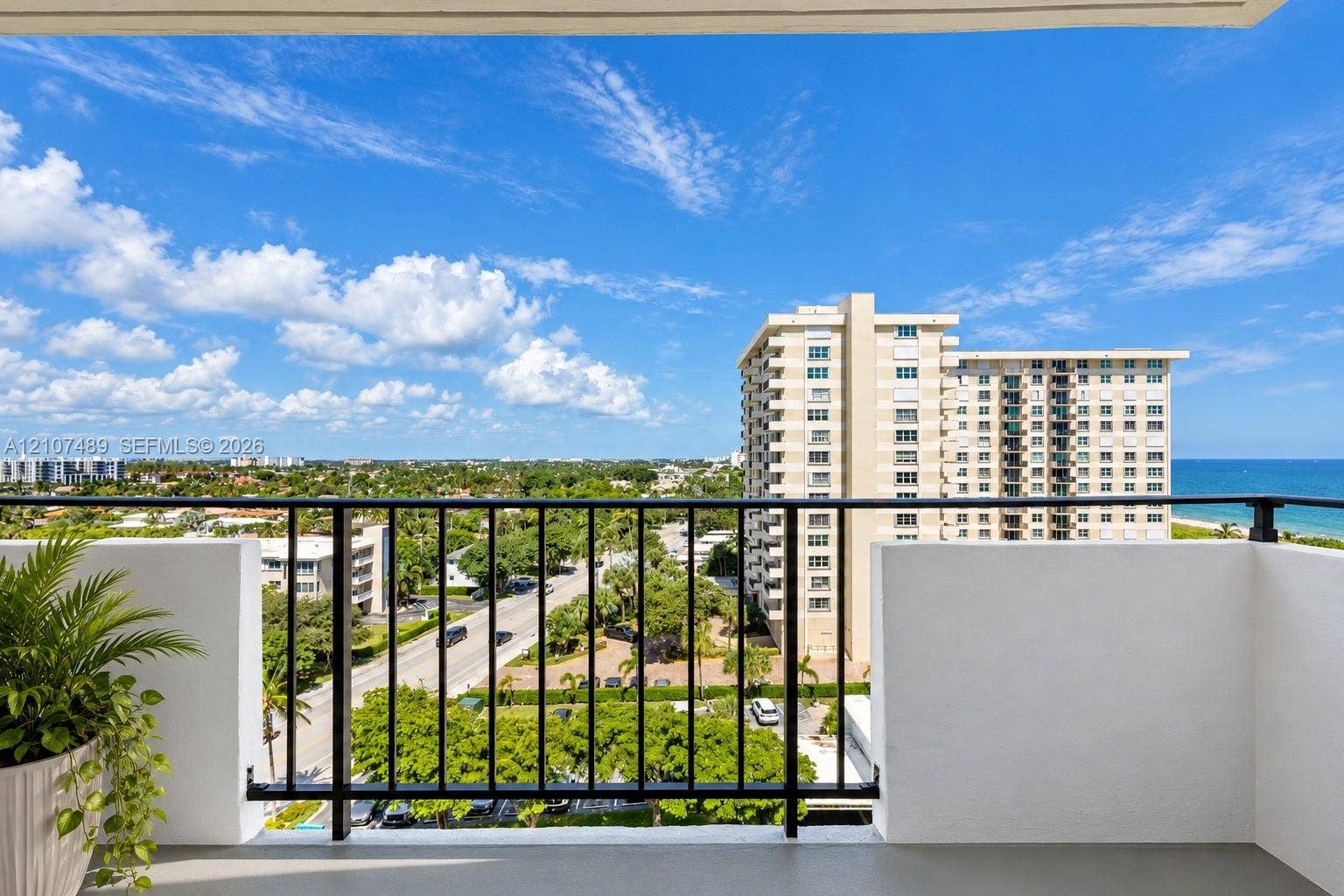 2000 S Ocean Boulevard, #9N, Lauderdale-By-The-Sea, Lauderdale By The Sea, FL 33062 Private balcony featuring a black metal railing and concrete flooring, overlooking the coastline and urban landscape