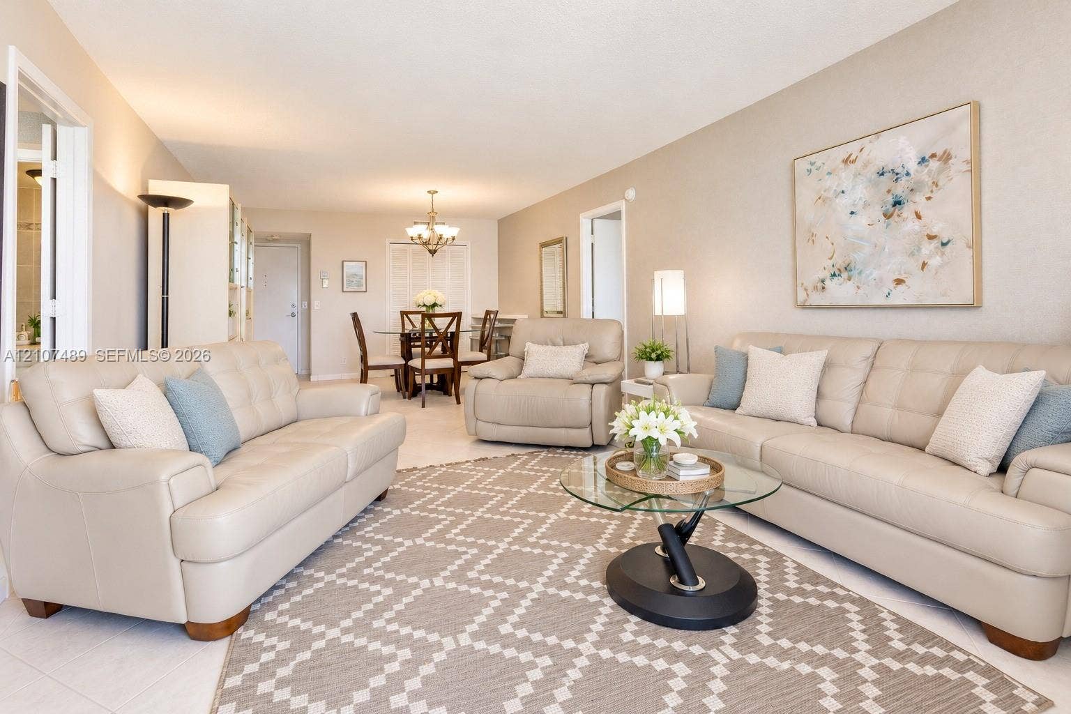 2000 S Ocean Boulevard, #9N, Lauderdale-By-The-Sea, Lauderdale By The Sea, FL 33062 Neutral-toned interior space featuring light-colored tile flooring, overhead recessed lighting, and a multi-light chandelier fixture