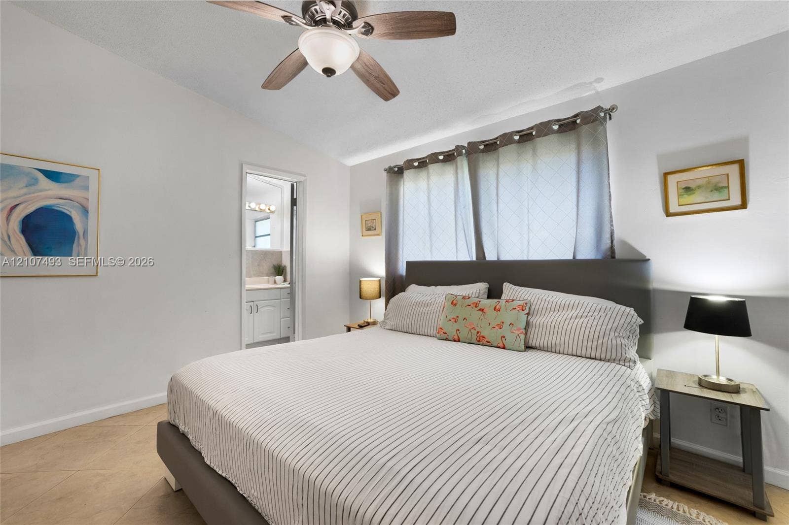 2645 NE 32nd Street, Fort Lauderdale, FL 33306 Neutral interior featuring tile flooring, a multi-blade ceiling fan with integrated lighting, and horizontal window treatments
