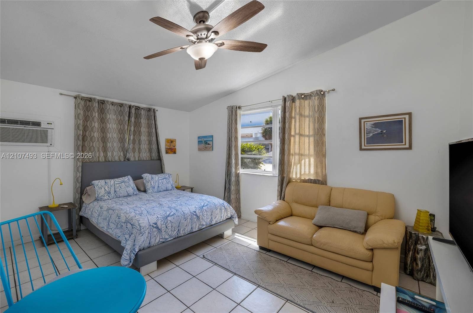 2645 NE 32nd Street, Fort Lauderdale, FL 33306 Room featuring white tile flooring, a multi-blade ceiling fan with integrated lighting, and dual windows