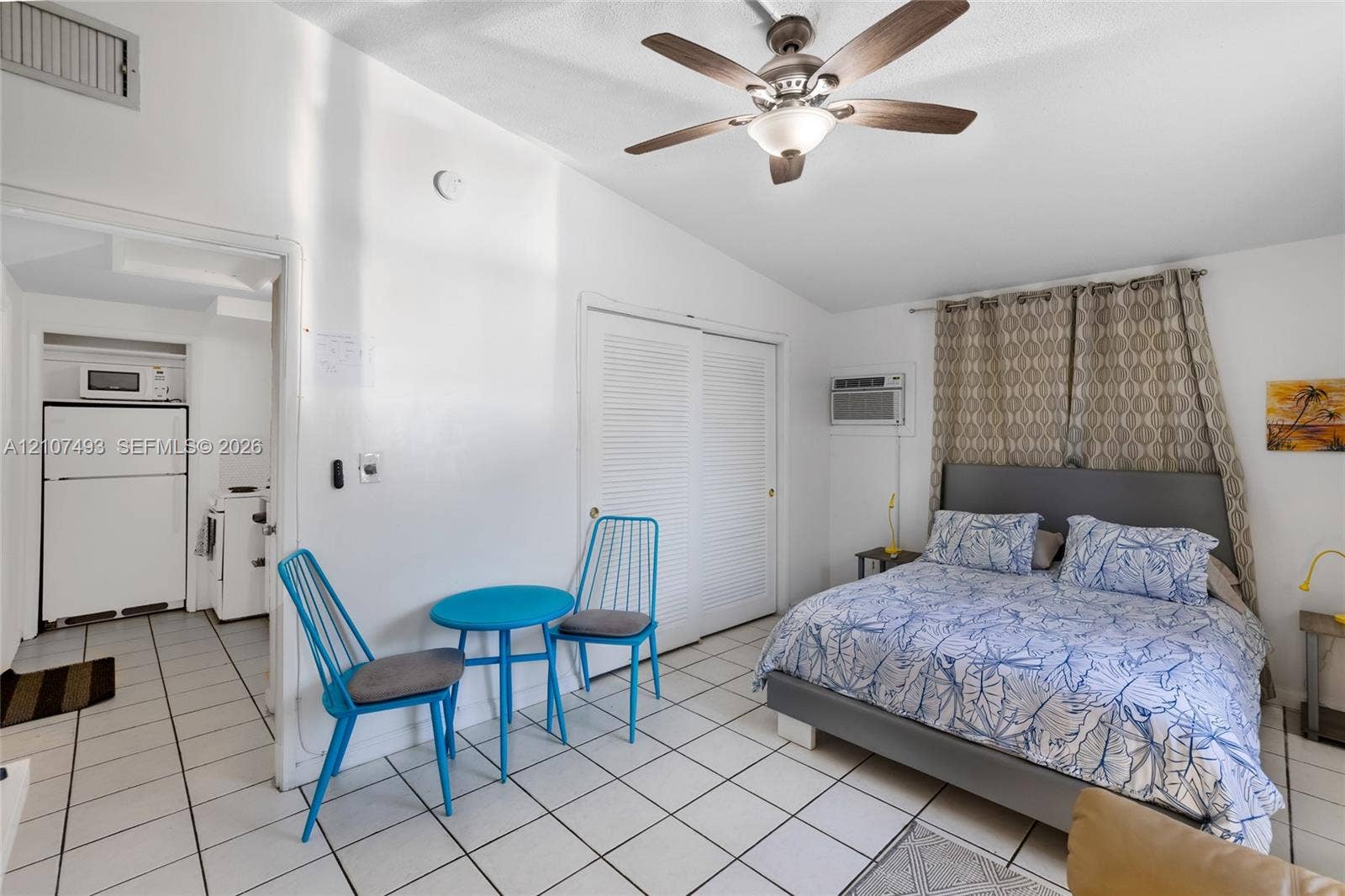 2645 NE 32nd Street, Fort Lauderdale, FL 33306 Tile flooring, vaulted ceilings, ceiling fan with integrated lighting, and louvered double-door closet