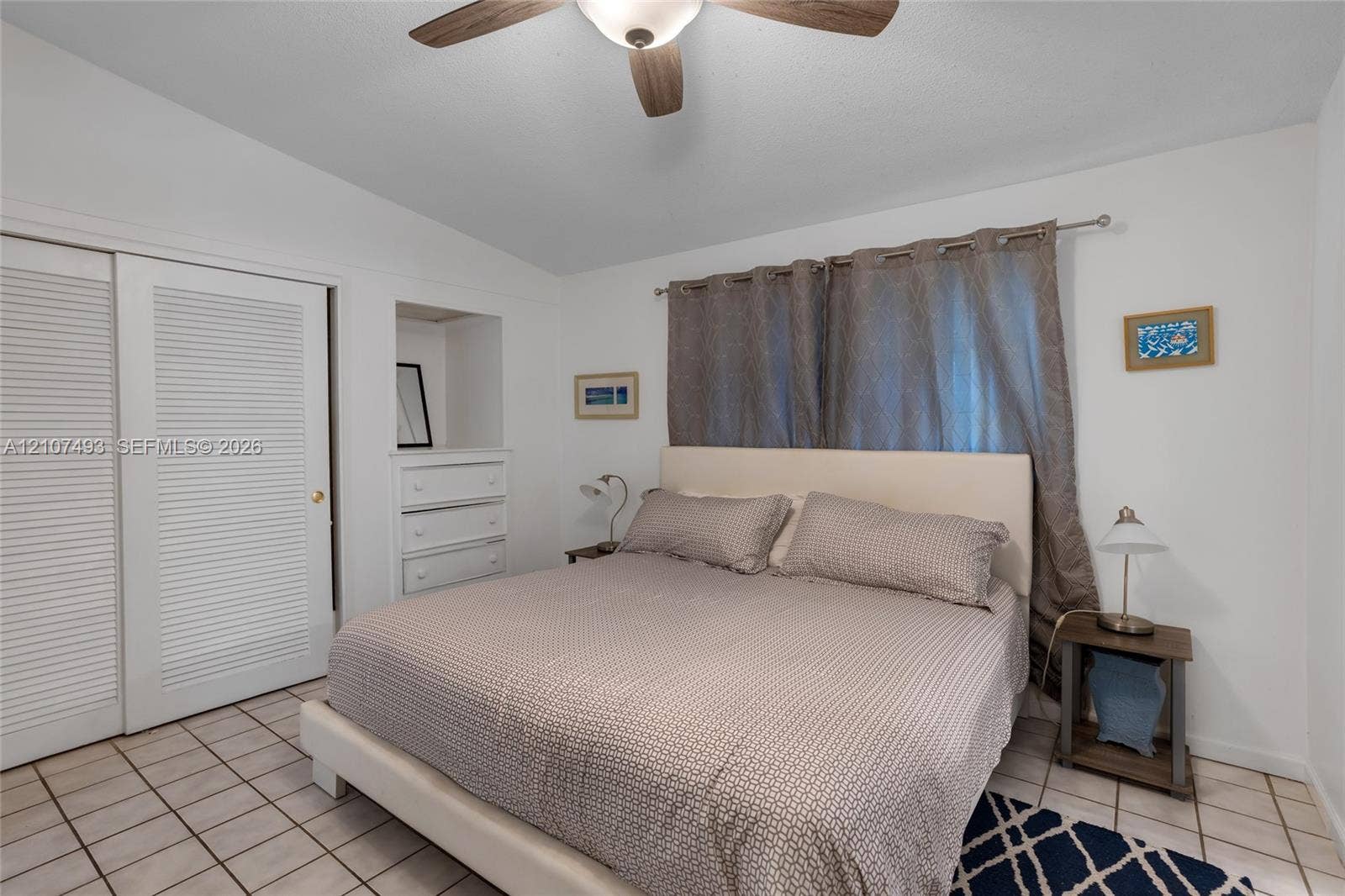 2645 NE 32nd Street, Fort Lauderdale, FL 33306 Ceramic tile flooring, built-in recessed cabinetry, and ceiling fan with integrated lighting