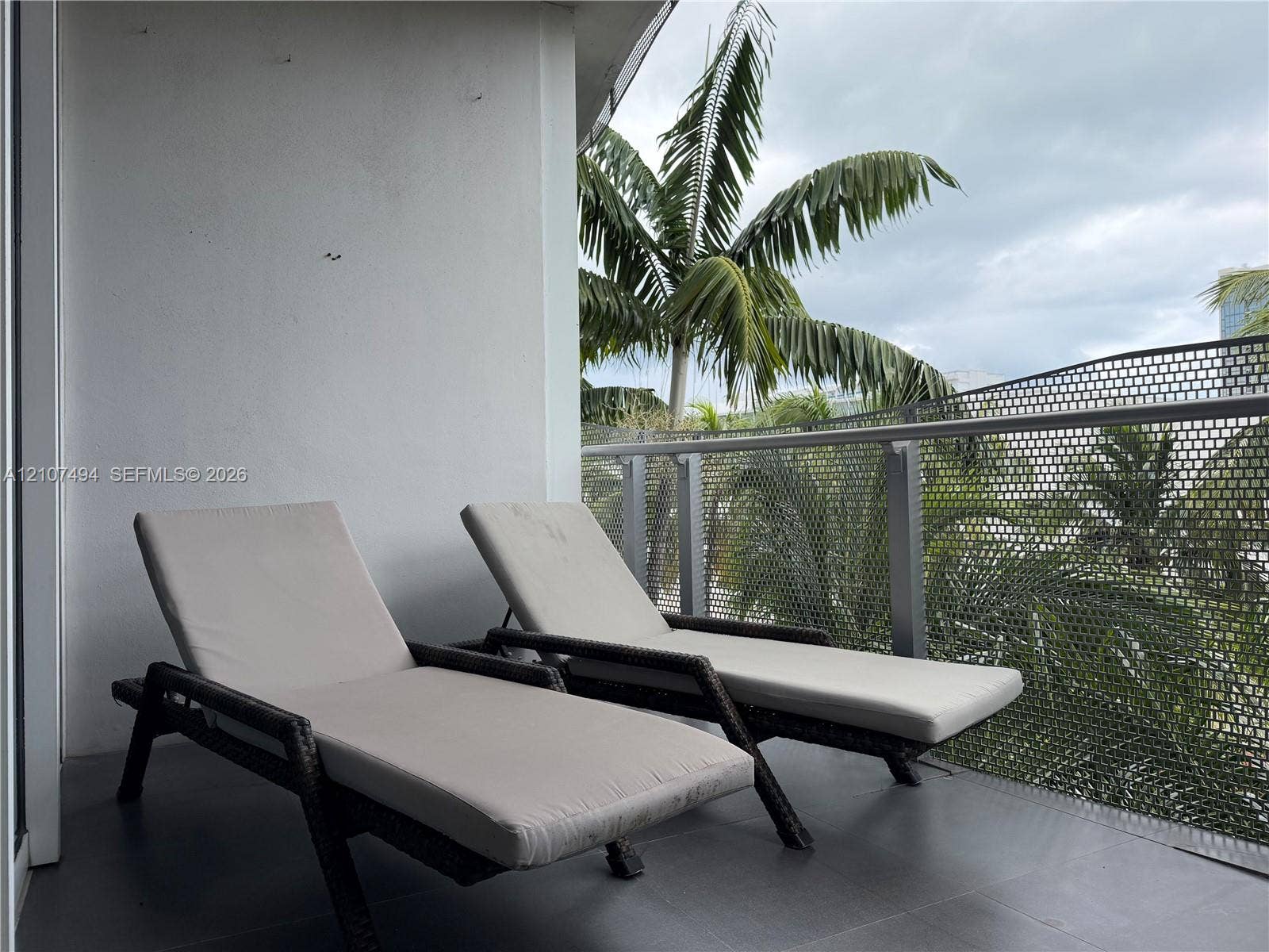 2100 Park Avenue, #305, Miami Beach, Miami Beach, FL 33139 Covered balcony featuring grey floor tiling and a metal perforated railing