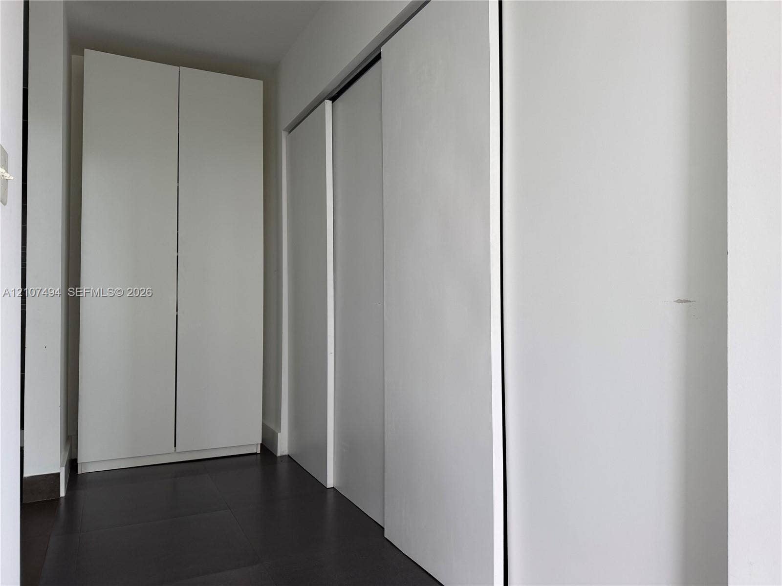 2100 Park Avenue, #305, Miami Beach, Miami Beach, FL 33139 Floor-to-ceiling cabinetry with smooth white finish and dark tile flooring