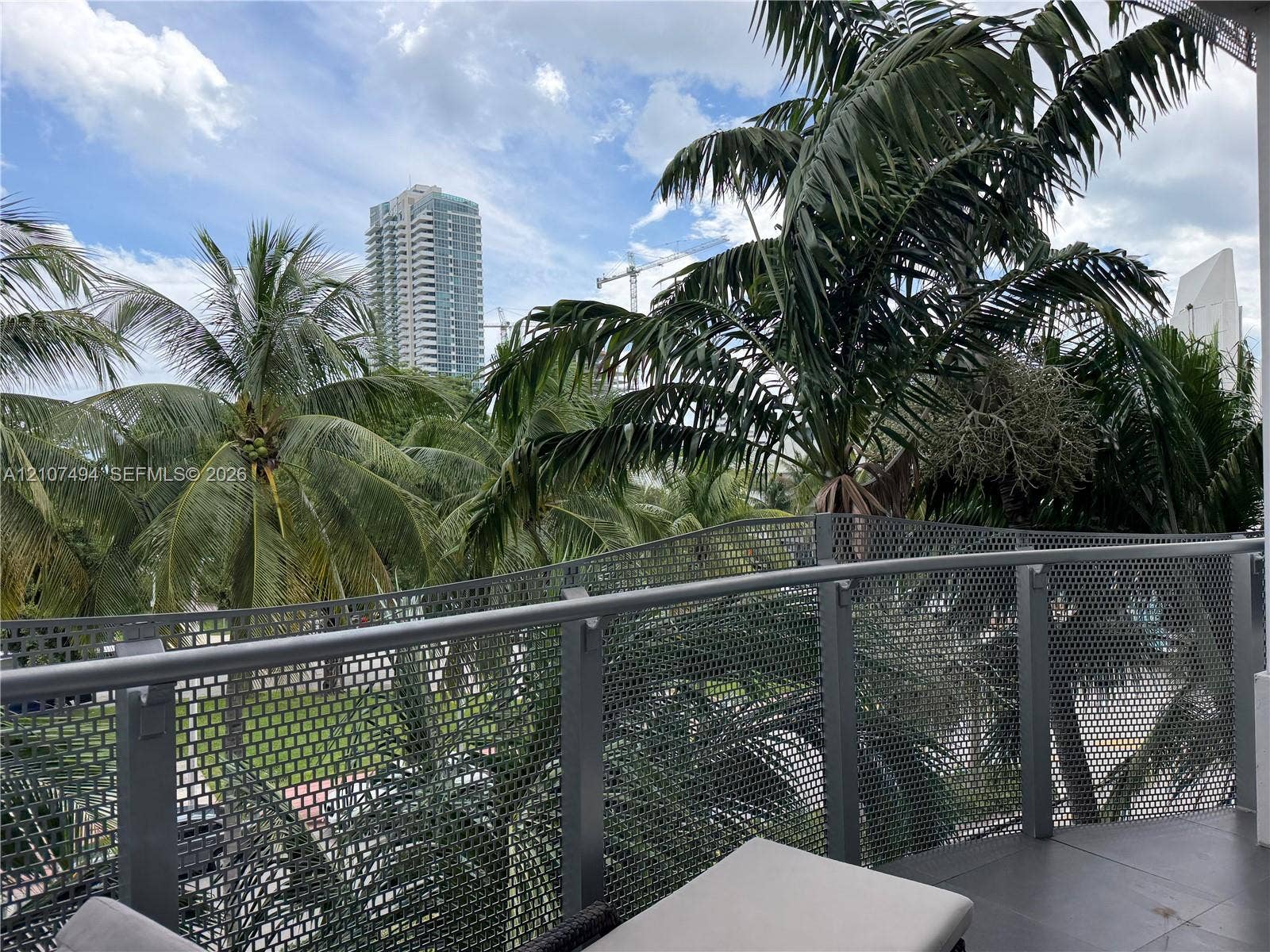 2100 Park Avenue, #305, Miami Beach, Miami Beach, FL 33139 Private balcony featuring a grey metal mesh railing, horizontal handrail, and large-format tile flooring