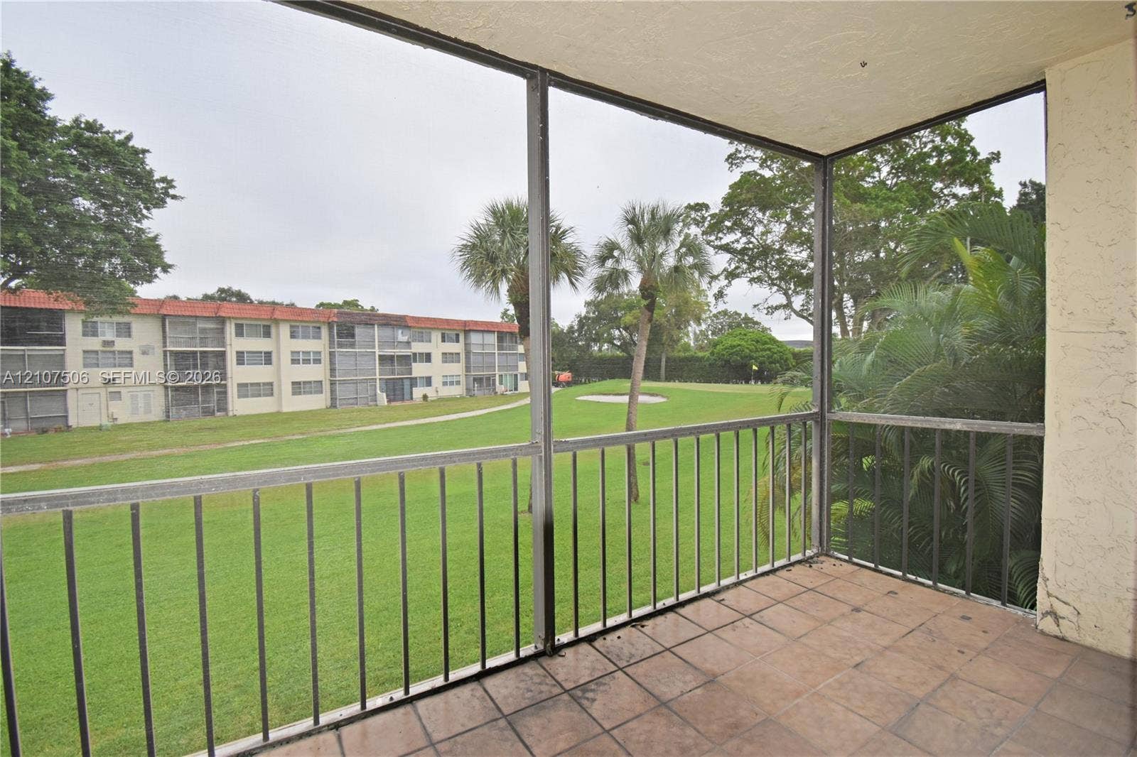 830 S Hollybrook Drive, #207, Pembroke Pines, FL 33025 Screened balcony featuring ceramic tile flooring and metal railings