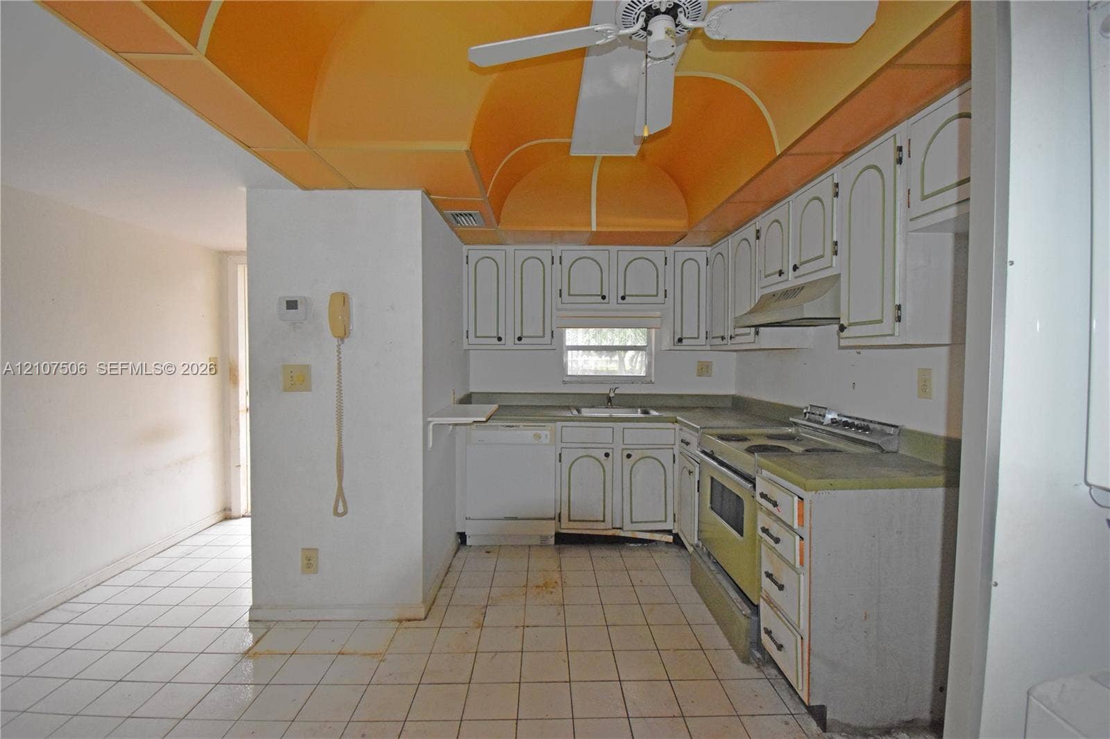 830 S Hollybrook Drive, #207, Pembroke Pines, FL 33025 Kitchen featuring arched ceiling detail, white cabinetry with integrated hardware, ceramic tile flooring, and built-in appliances