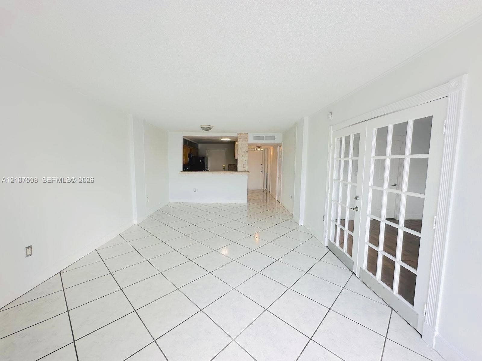 1020 Meridian Avenue, #415, Miami Beach, Miami Beach, FL 33139 Large-format white tile flooring, French doors with glass panes, and a pass-through kitchen opening