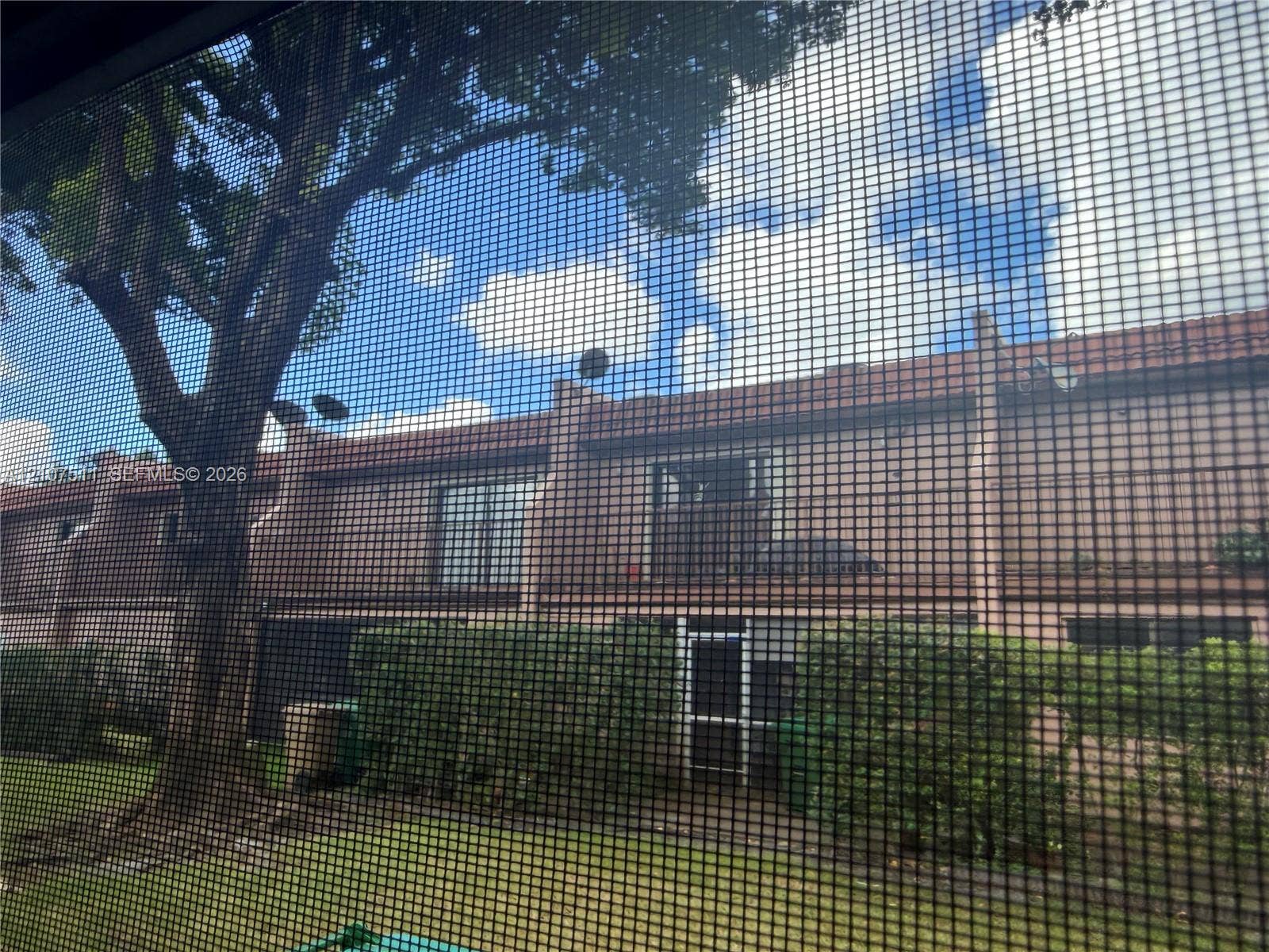 12 S Valencia Drive, #5-4, Davie, FL 33324 Multi-story exterior featuring a masonry facade, balcony, mature trees, and landscaping