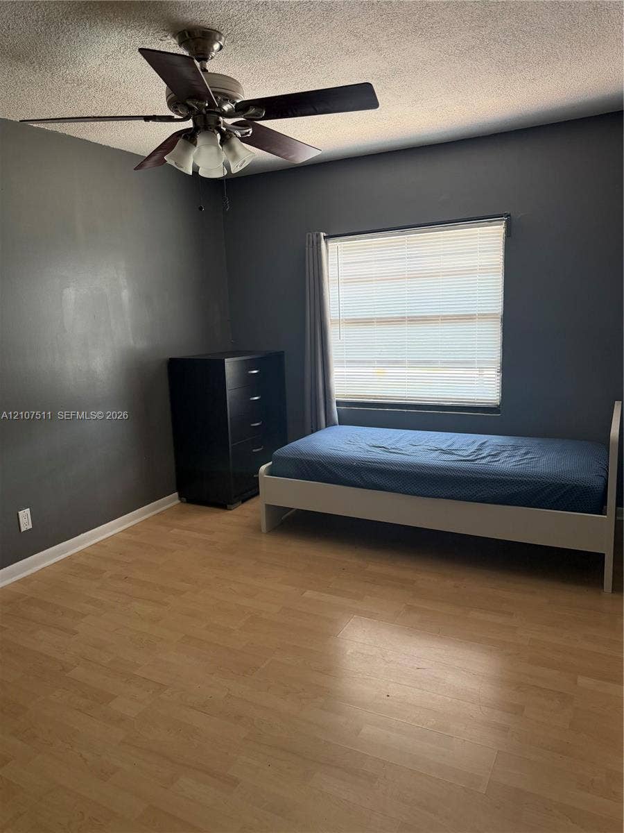 12 S Valencia Drive, #5-4, Davie, FL 33324 Wood-finish flooring, ceiling fan with integrated light fixture, and horizontal window blinds