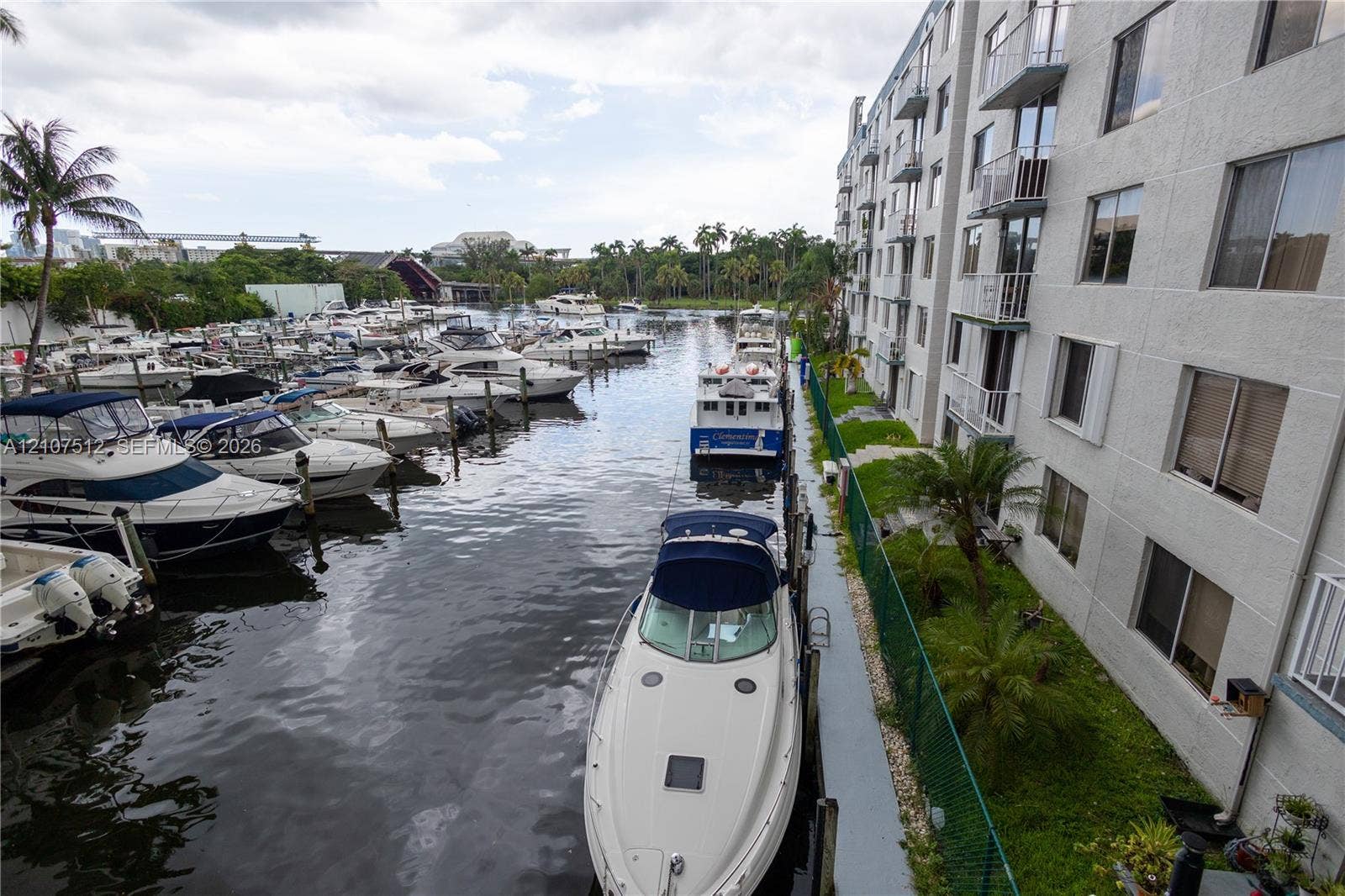 1720 N River Drive, #302, Miami, FL 33125 Waterfront multi-story building featuring structural balconies and direct access to boat slips