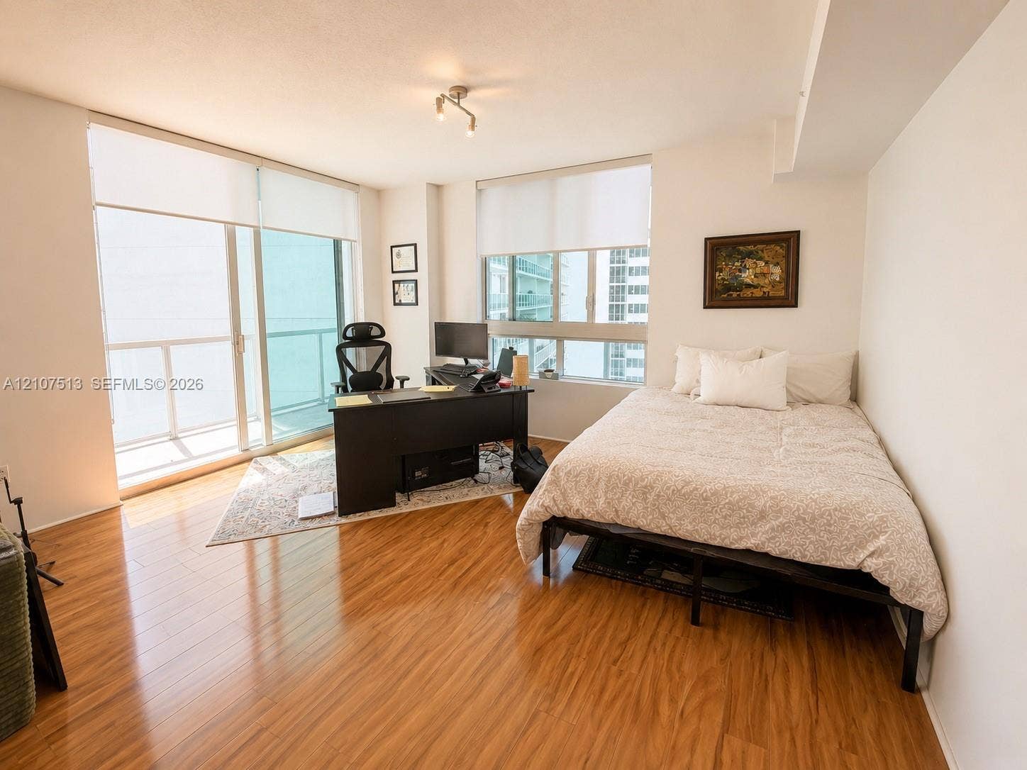 1900 N Bayshore Drive, #3005, Miami, FL 33132 Wood-finish flooring, floor-to-ceiling windows, sliding glass door, and a private balcony