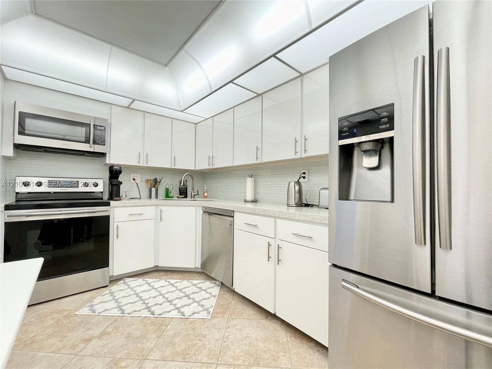 2750 NE 183rd Street, #2310, Aventura, Aventura, FL 33160 Kitchen featuring white gloss cabinetry, stone-finish countertops, stainless steel appliances, recessed ceiling lighting, and tiled flooring