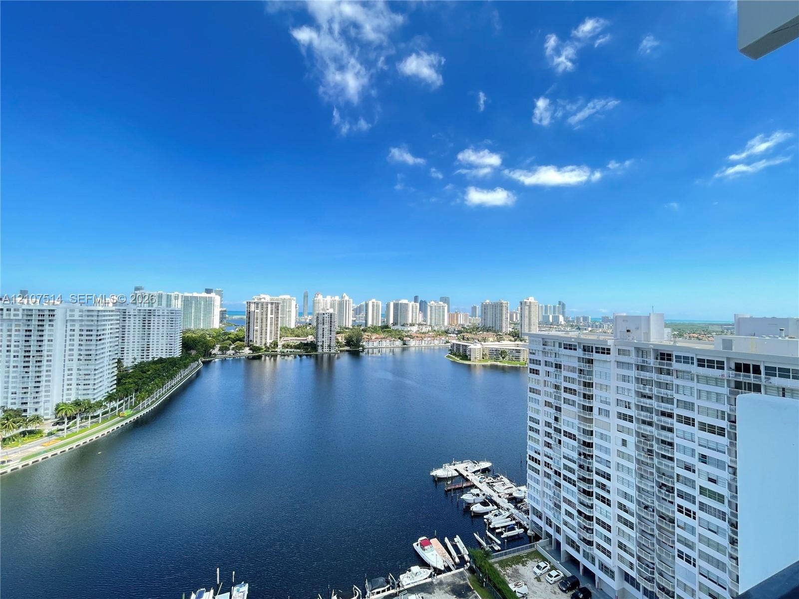 2750 NE 183rd Street, #2310, Aventura, Aventura, FL 33160 High-rise balcony perspective featuring expansive water frontage, boat slips, and a cityscape skyline