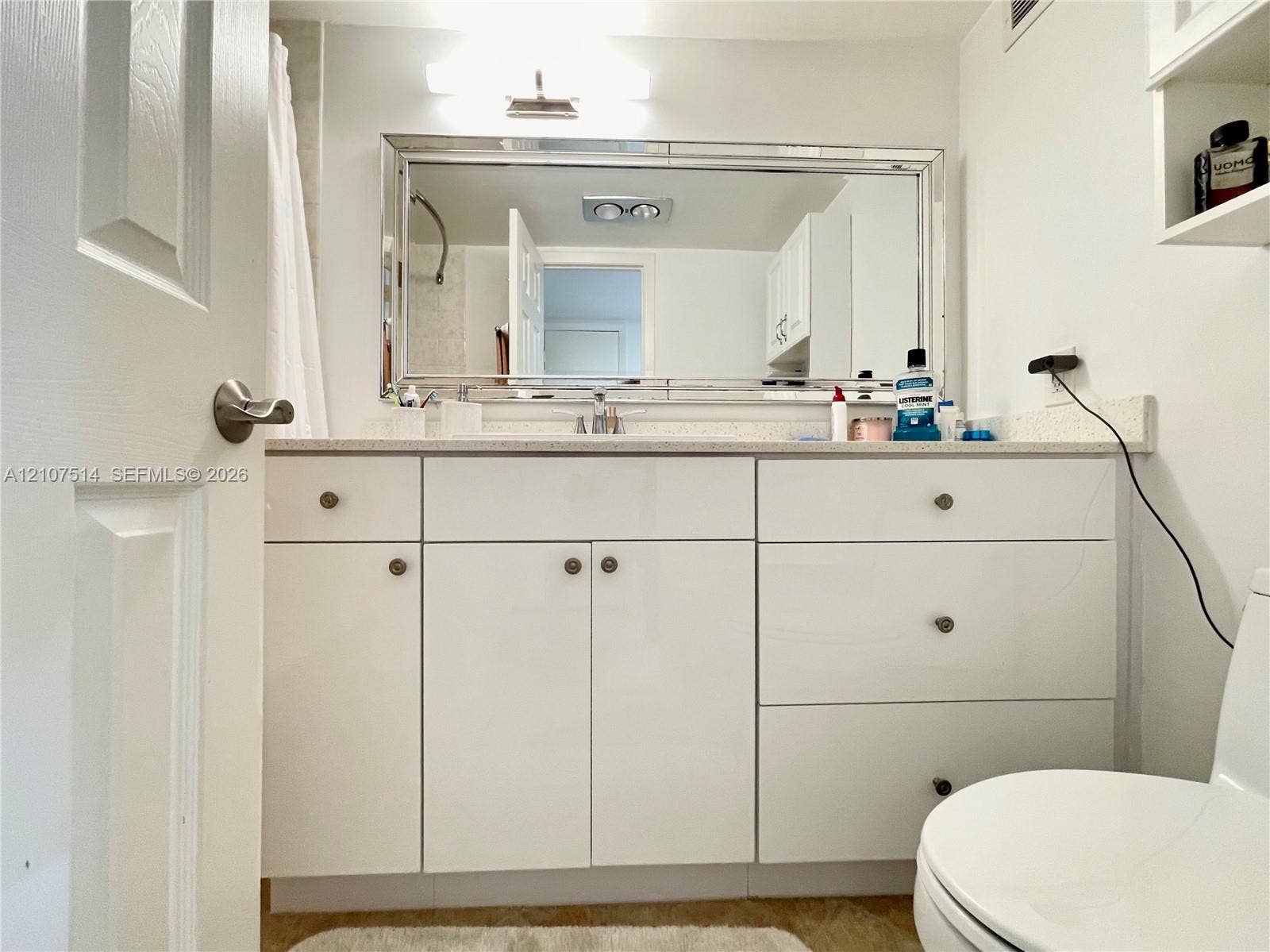 2750 NE 183rd Street, #2310, Aventura, Aventura, FL 33160 Bathroom vanity with white cabinetry, flat-panel doors, integrated drawers, stone-finish countertop, and a large rectangular mirror