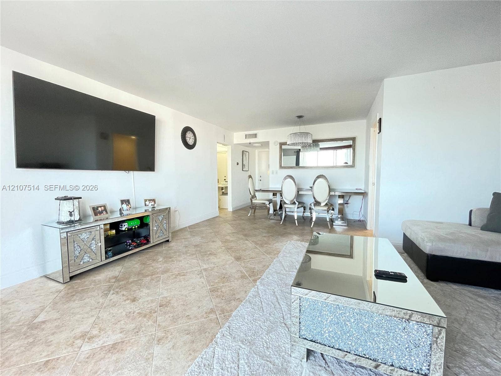 2750 NE 183rd Street, #2310, Aventura, Aventura, FL 33160 Open-concept floor plan featuring neutral stone-finish tile flooring throughout and a modern drum-style chandelier fixture