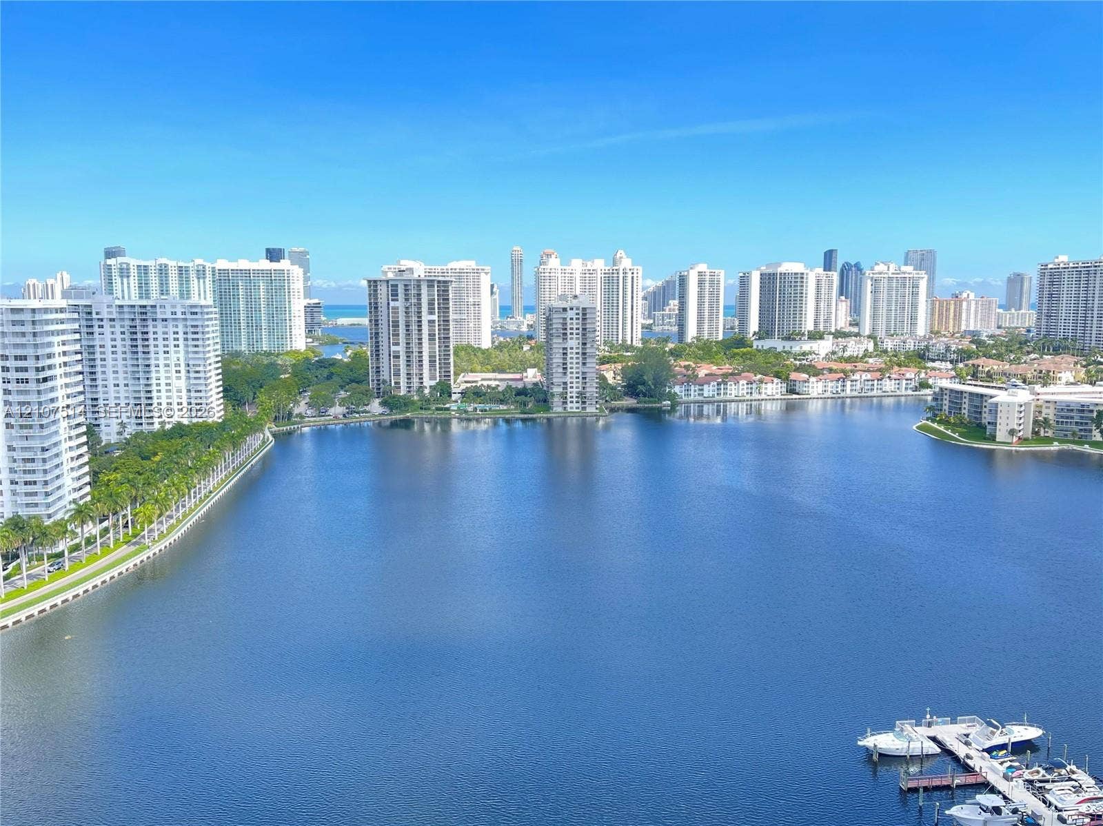 2750 NE 183rd Street, #2310, Aventura, Aventura, FL 33160 Panoramic water expanse with a private boat dock and surrounding coastal high-rise development