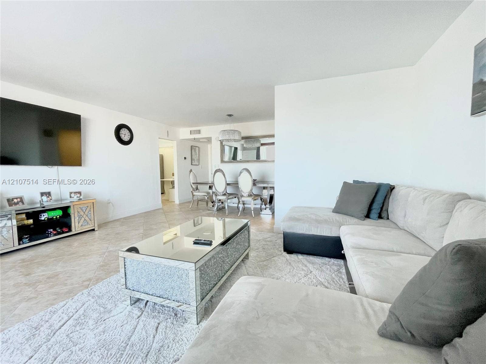 2750 NE 183rd Street, #2310, Aventura, Aventura, FL 33160 Open-concept floor plan featuring neutral tile flooring, smooth wall finishes, and a dedicated dining area with a modern drum-style pendant light fixture