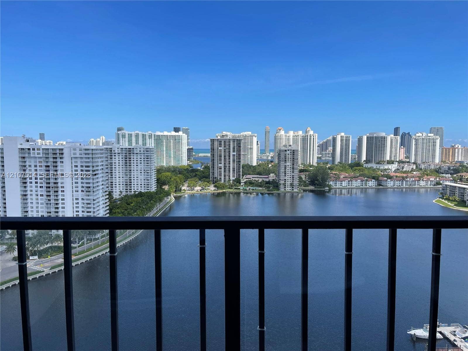 2750 NE 183rd Street, #2310, Aventura, Aventura, FL 33160 Balcony with black metal railing overlooking a waterfront and city skyline