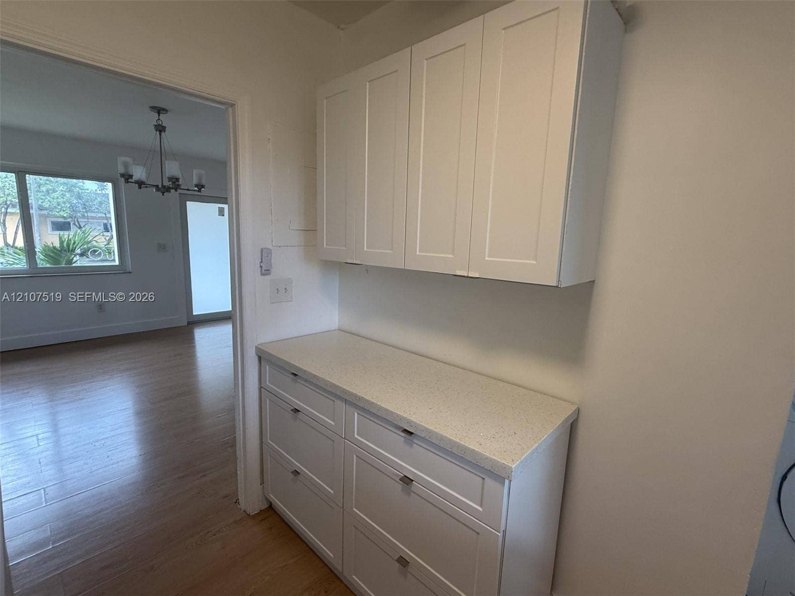 1201 SW 13th Street, #1205, Miami, Miami, FL 33145 Shaker-style cabinetry with white finish, light-toned composite countertop, and wood-finish flooring