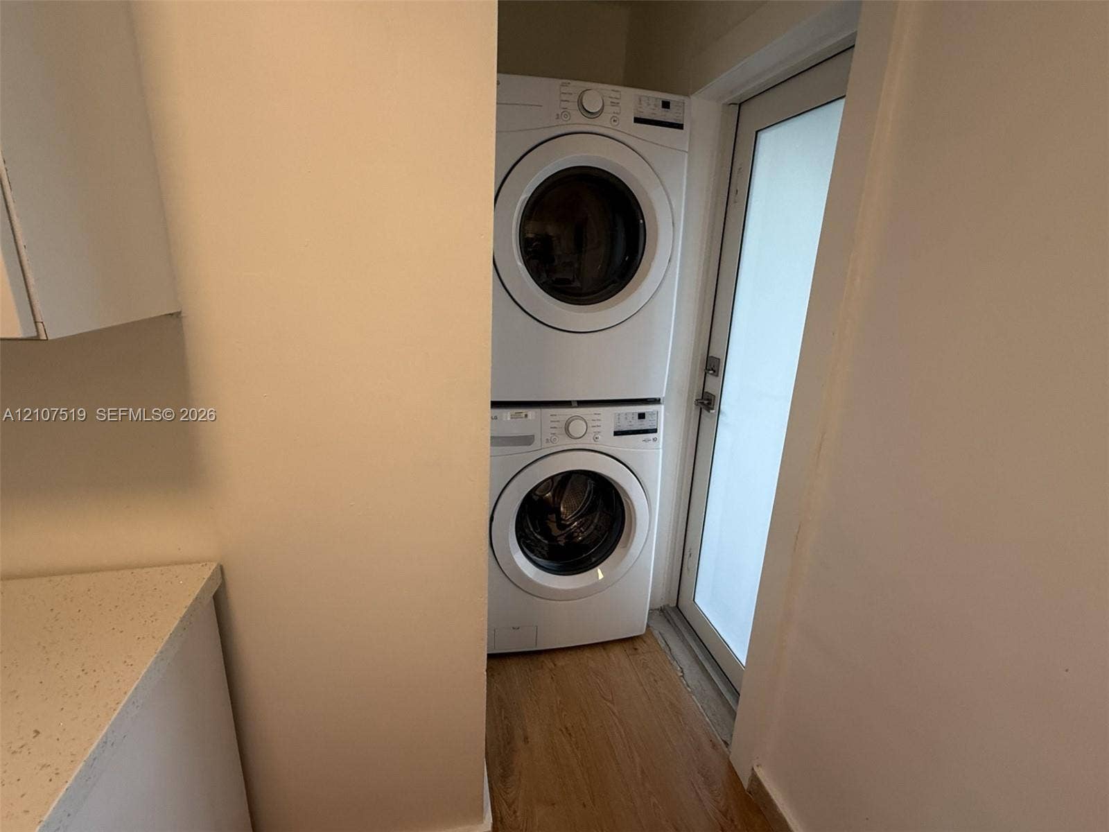 1201 SW 13th Street, #1205, Miami, Miami, FL 33145 Stacked laundry unit with wood-finish flooring and glass-paneled exterior door
