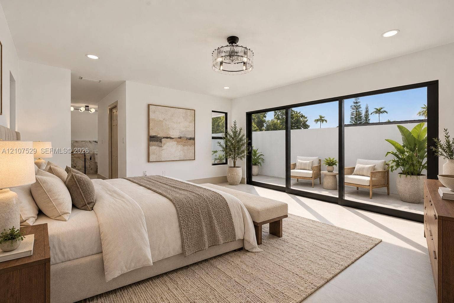 Floor-to-ceiling sliding glass doors with black frames, recessed ceiling lighting, a tiered drum-style chandelier, and light-toned tile flooring