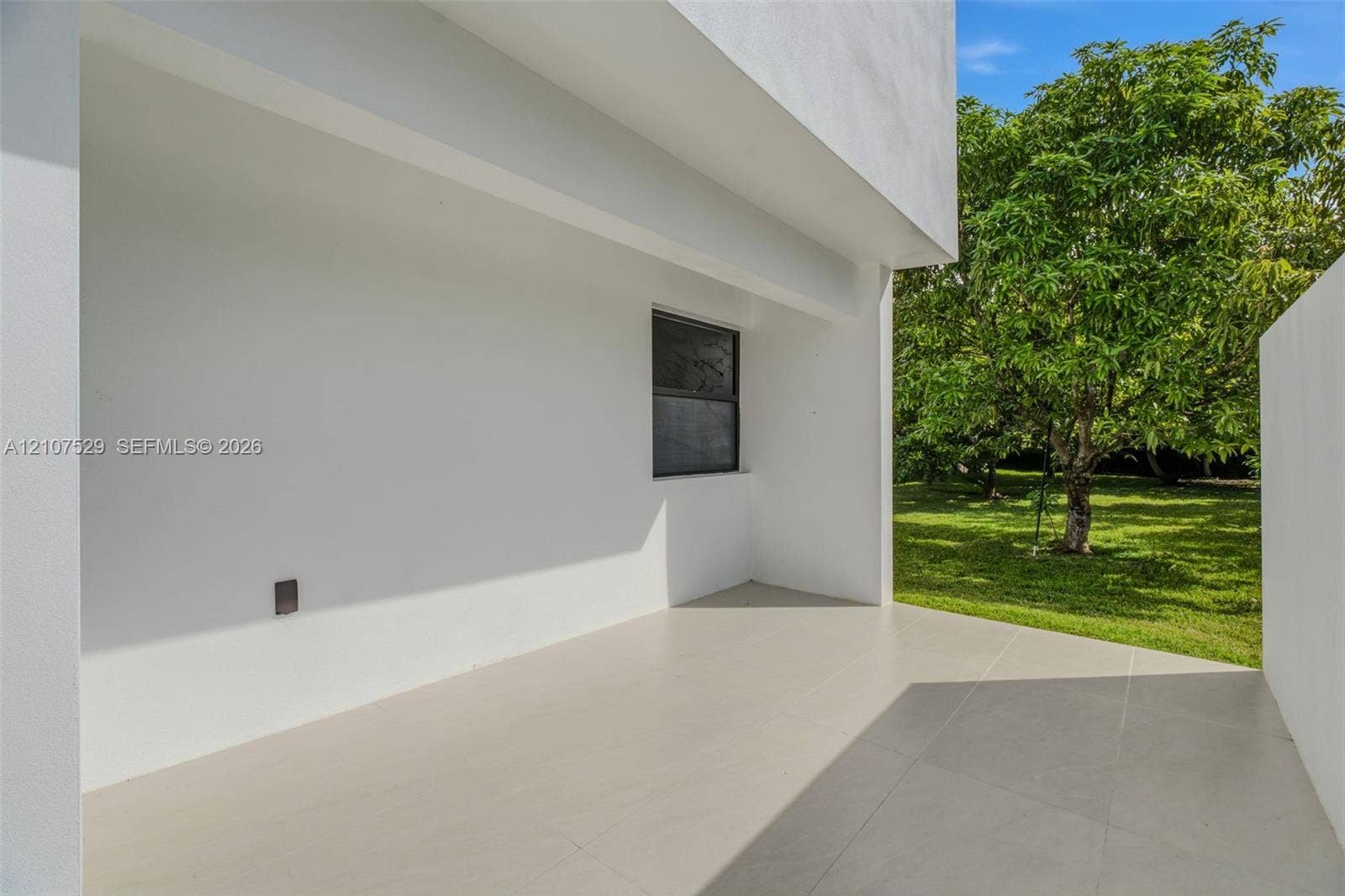Neutral interior featuring oversized tile flooring, recessed lighting, a modern drum ceiling fixture, and custom-painted six-panel interior and sliding closet doors