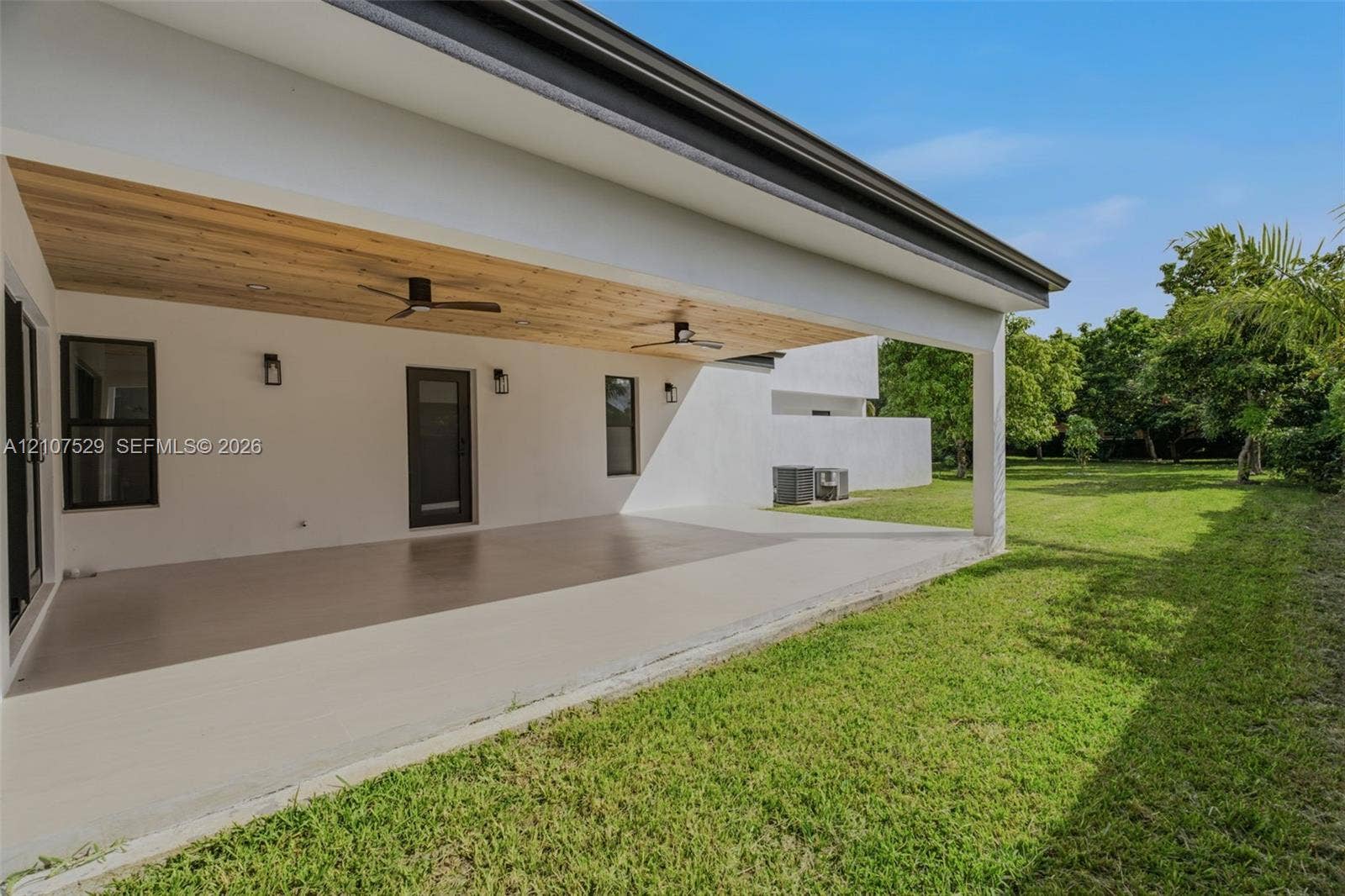 Covered patio featuring a wood-plank ceiling, recessed lighting, ceiling fans, and concrete flooring