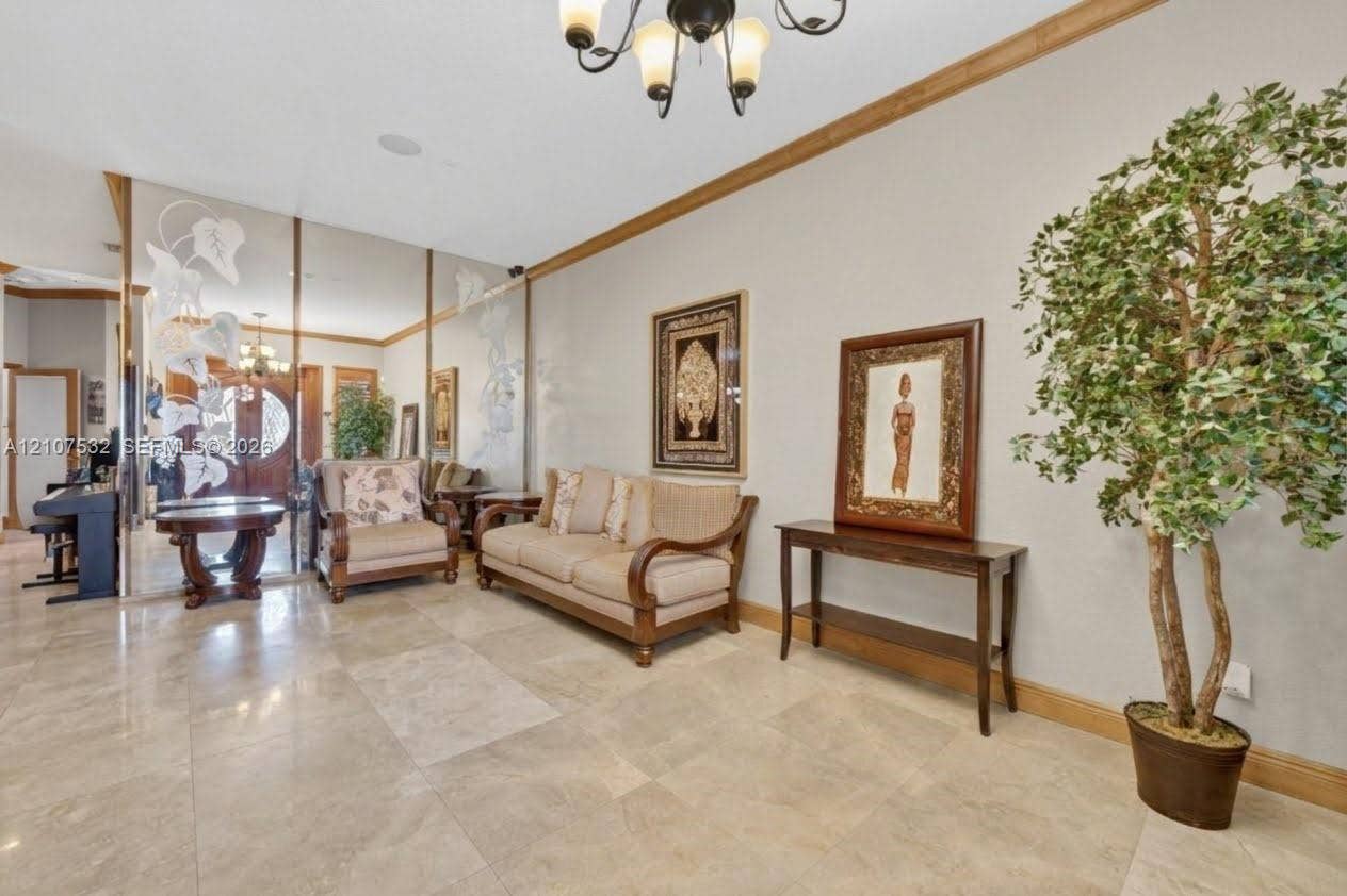 9124 NW 147th Terrace, Miami Lakes, FL 33018 Large-format stone tile flooring, wall-to-wall mirrored panels featuring decorative frosted etching, and crown molding