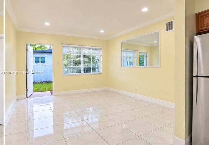 Glossy tile flooring, recessed ceiling lighting, a large wall-mounted mirror, and a multi-lite glass panel door
