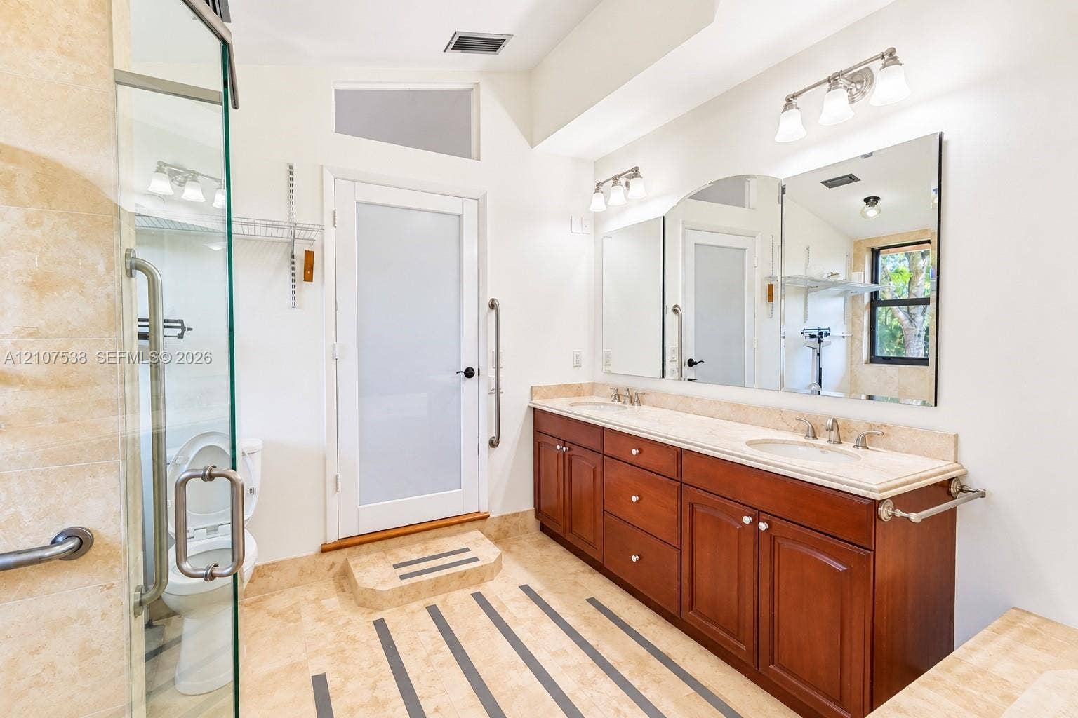 10204 SW 96th Court, Miami, Miami, FL 33176 Bathroom featuring a dual-sink vanity with wood cabinetry and stone countertops, glass-enclosed shower, large wall-mounted mirror, and tile flooring