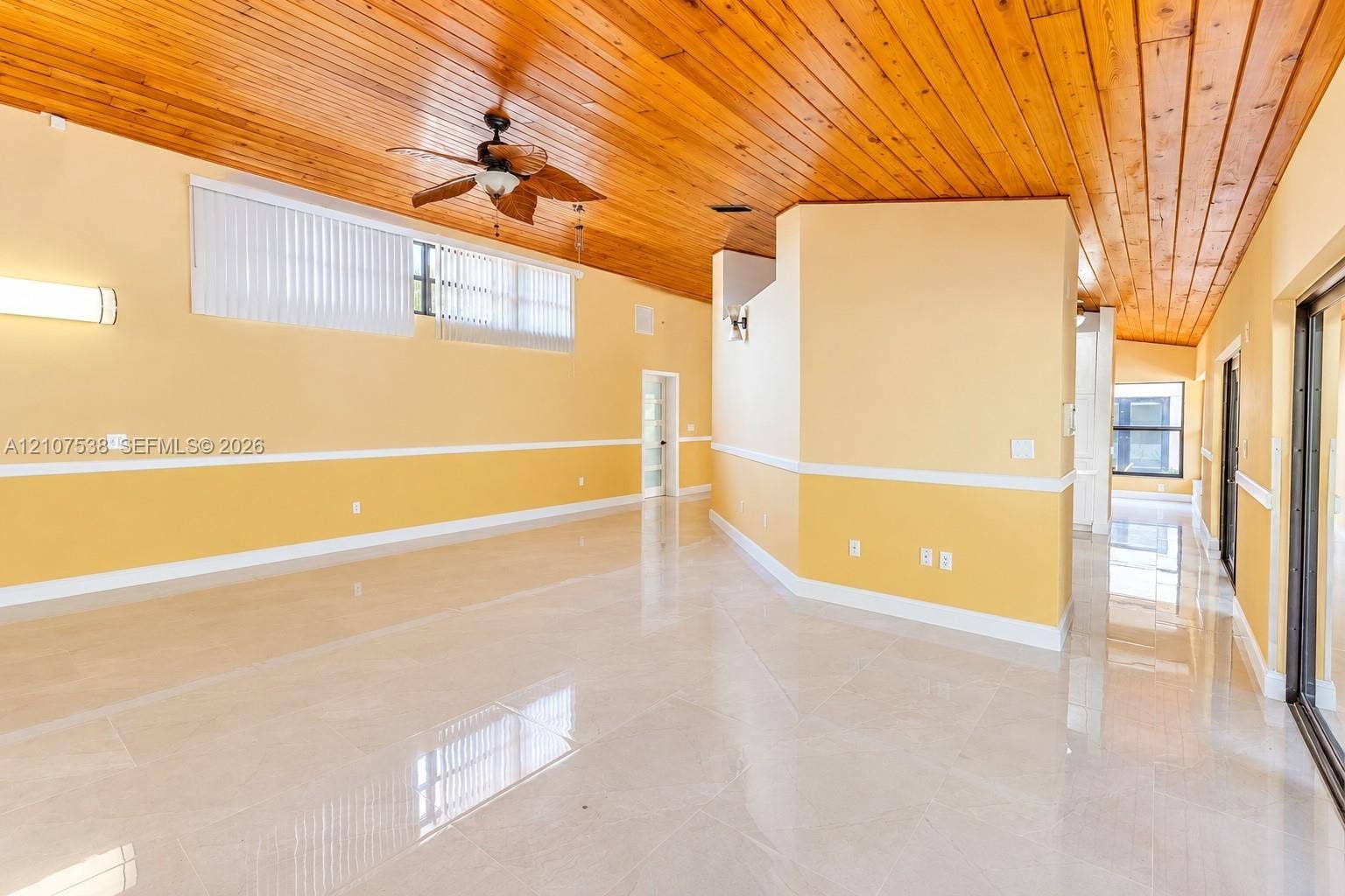 10204 SW 96th Court, Miami, Miami, FL 33176 Interior featuring vaulted tongue-and-groove wood ceilings, polished tile flooring, horizontal window arrays, and a ceiling fan