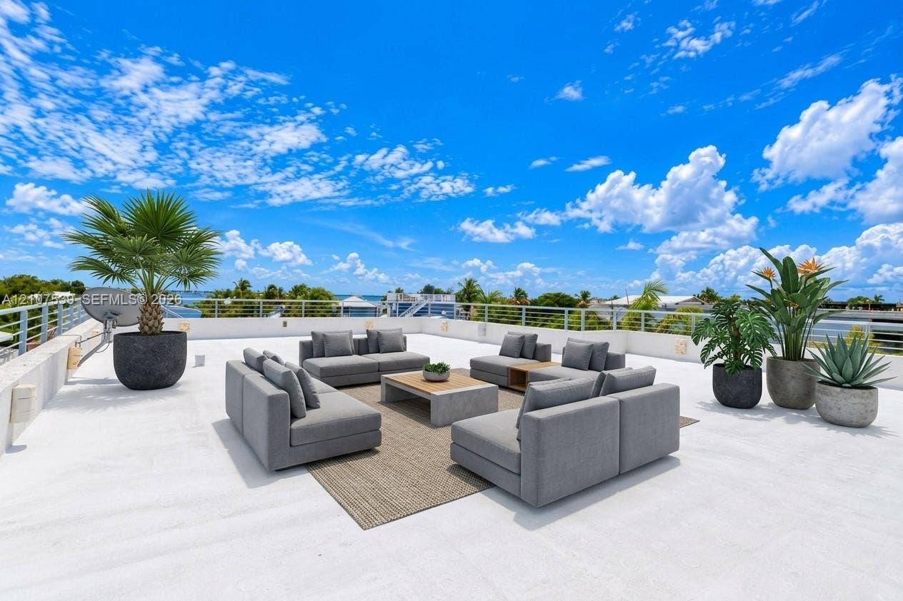 20 Center Lane, Key Largo, FL 33037 Expansive rooftop terrace featuring white flat surfacing, horizontal cable railings, and wall-mounted exterior lighting