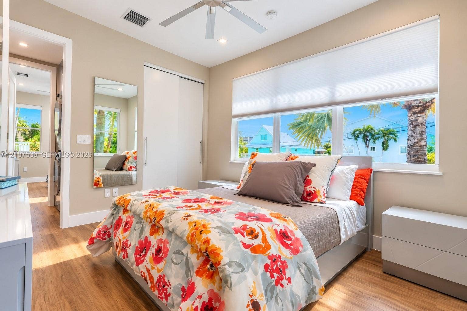 20 Center Lane, Key Largo, FL 33037 Wood-finish flooring, large sliding closet with integrated door hardware, ceiling fan with light fixture, and horizontal window treatments