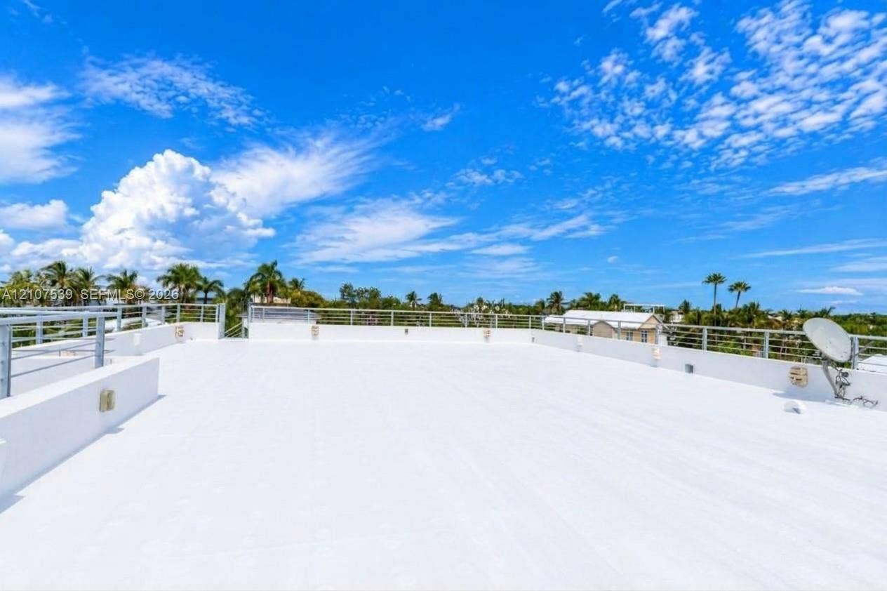 20 Center Lane, Key Largo, FL 33037 Expansive rooftop terrace featuring a flat, white deck surface and a metallic horizontal-bar railing