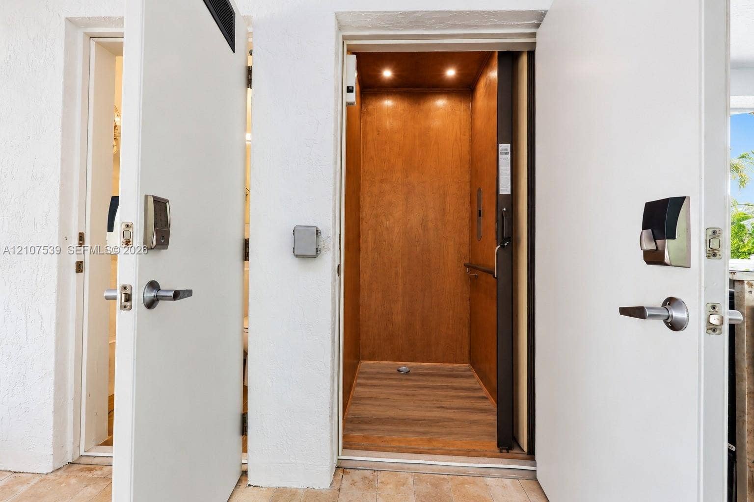 20 Center Lane, Key Largo, FL 33037 Private elevator featuring wood-paneled walls, recessed ceiling lighting, and wood-finish flooring