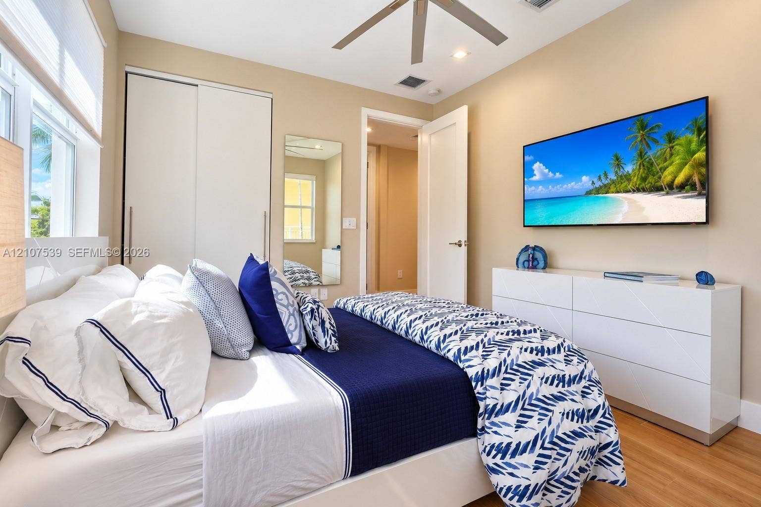20 Center Lane, Key Largo, FL 33037 Wood-finish flooring, ceiling fan, sliding-door closet, wall-mounted mirror, and multi-panel interior door