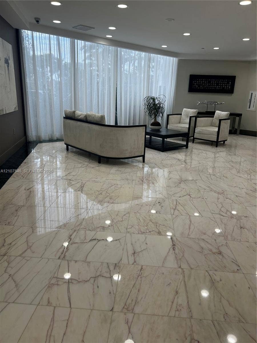 19333 Collins Avenue, #2007, Sunny Isles Beach, Sunny Isles Beach, FL 33160 Polished stone flooring with veining detail, floor-to-ceiling sheer window treatments, and recessed ceiling lighting