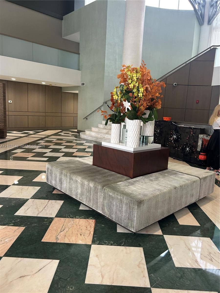 19333 Collins Avenue, #2007, Sunny Isles Beach, Sunny Isles Beach, FL 33160 Grand foyer featuring geometric stone flooring in a contrasting diamond pattern, multi-level architectural design, and integrated panel wall detailing