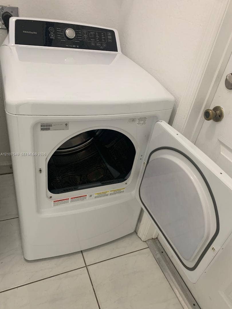 8995 NW 148th Street, #8995, Miami Lakes, Miami Lakes, FL 33018 White top-load Frigidaire dryer with an integrated digital control panel and tile flooring
