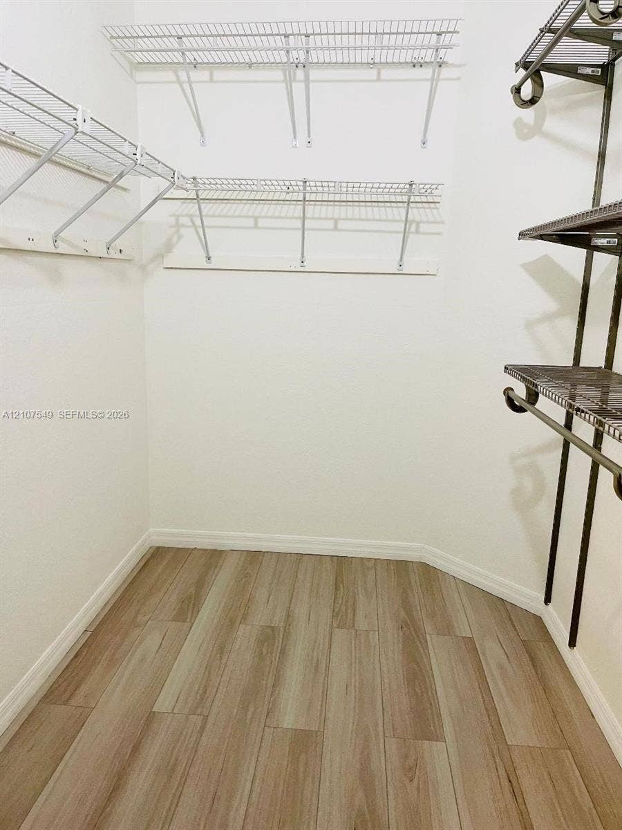8995 NW 148th Street, #8995, Miami Lakes, Miami Lakes, FL 33018 Walk-in storage space featuring wood-finish flooring and tiered metal shelving