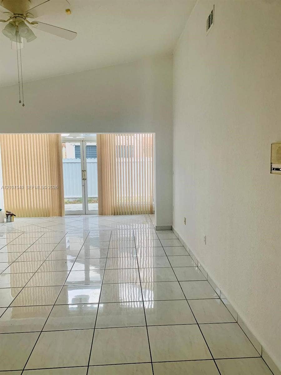 8995 NW 148th Street, #8995, Miami Lakes, Miami Lakes, FL 33018 Vaulted ceiling featuring a central light fixture with an integrated ceiling fan and polished tile flooring