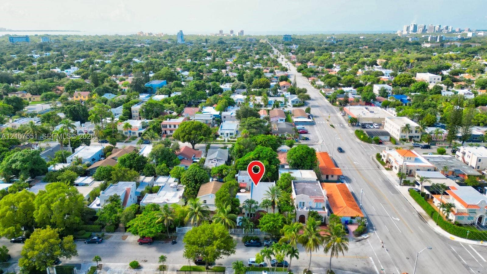 1676 SW 11th Street, Miami, Miami, FL 33135 Aerial perspective of a residential property featuring a tree-lined lot, mature palm trees, and proximity to urban infrastructure and coastal city centers