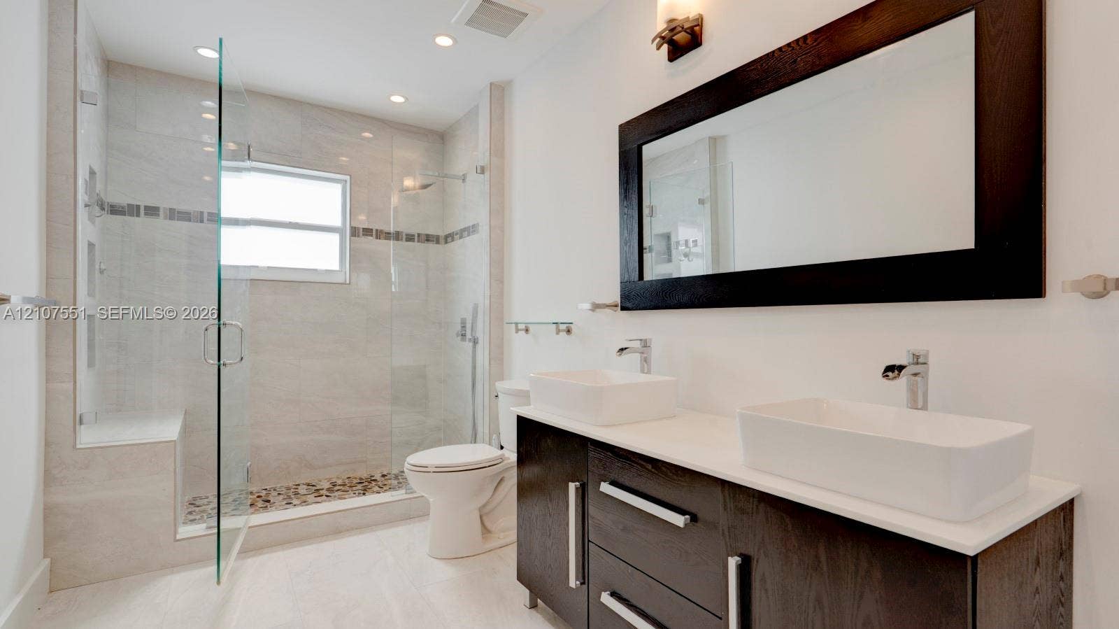 1676 SW 11th Street, Miami, Miami, FL 33135 Double vanity featuring rectangular vessel sinks, dark wood cabinetry, and a stone countertop